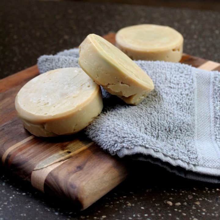 three bars of shaving soap on a wooden tray