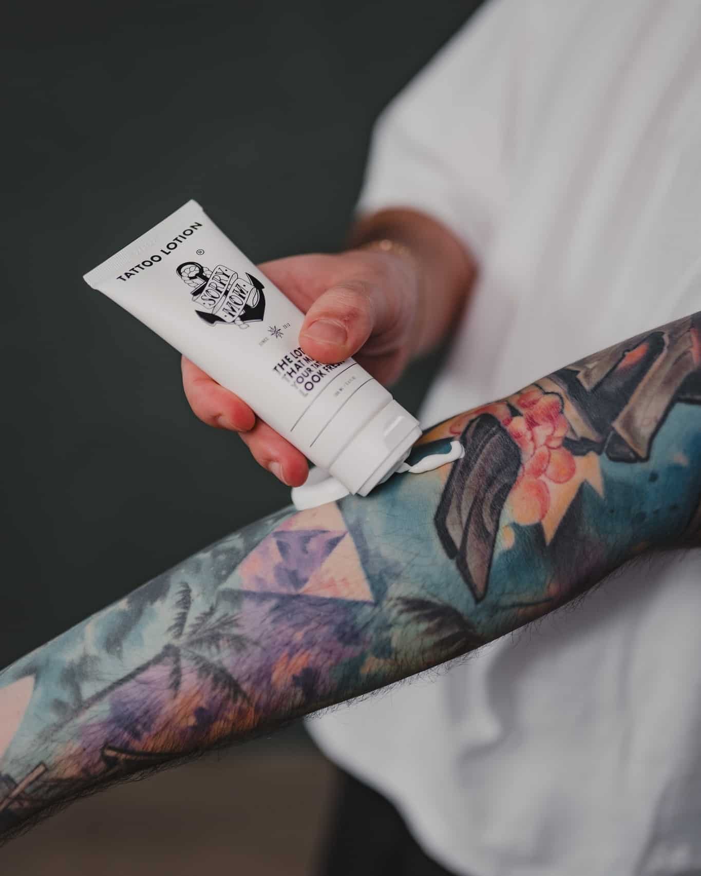applying a tattoo lotion on the arm