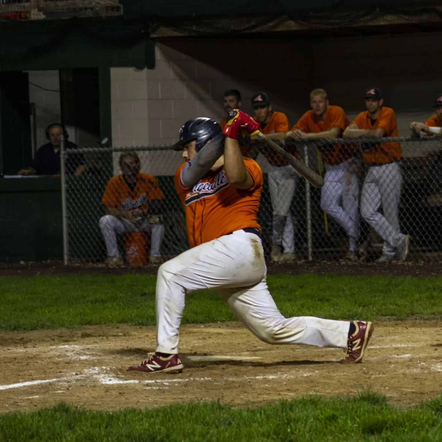 player swinging a baseball bat