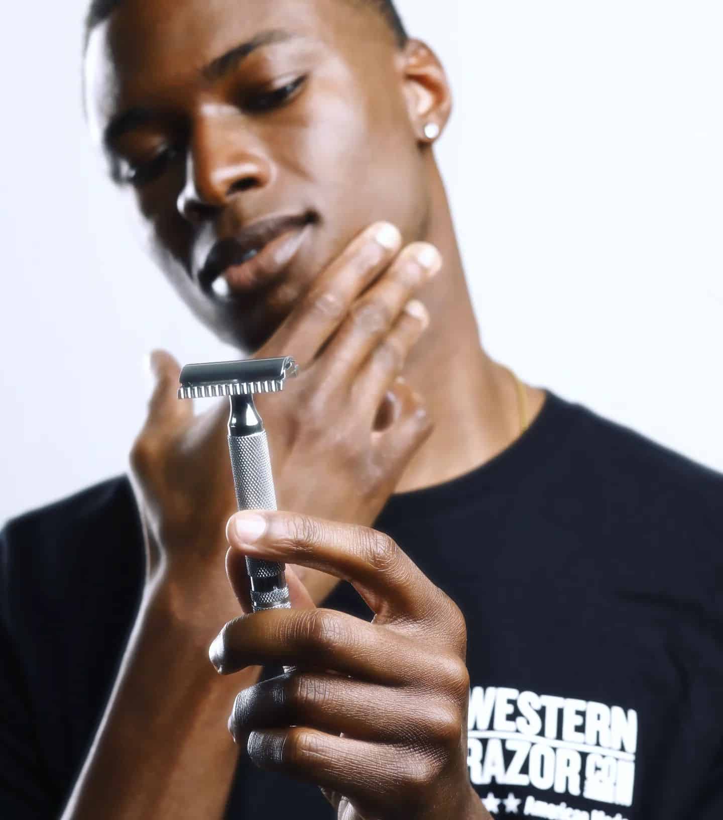 man holding a classic safety razor