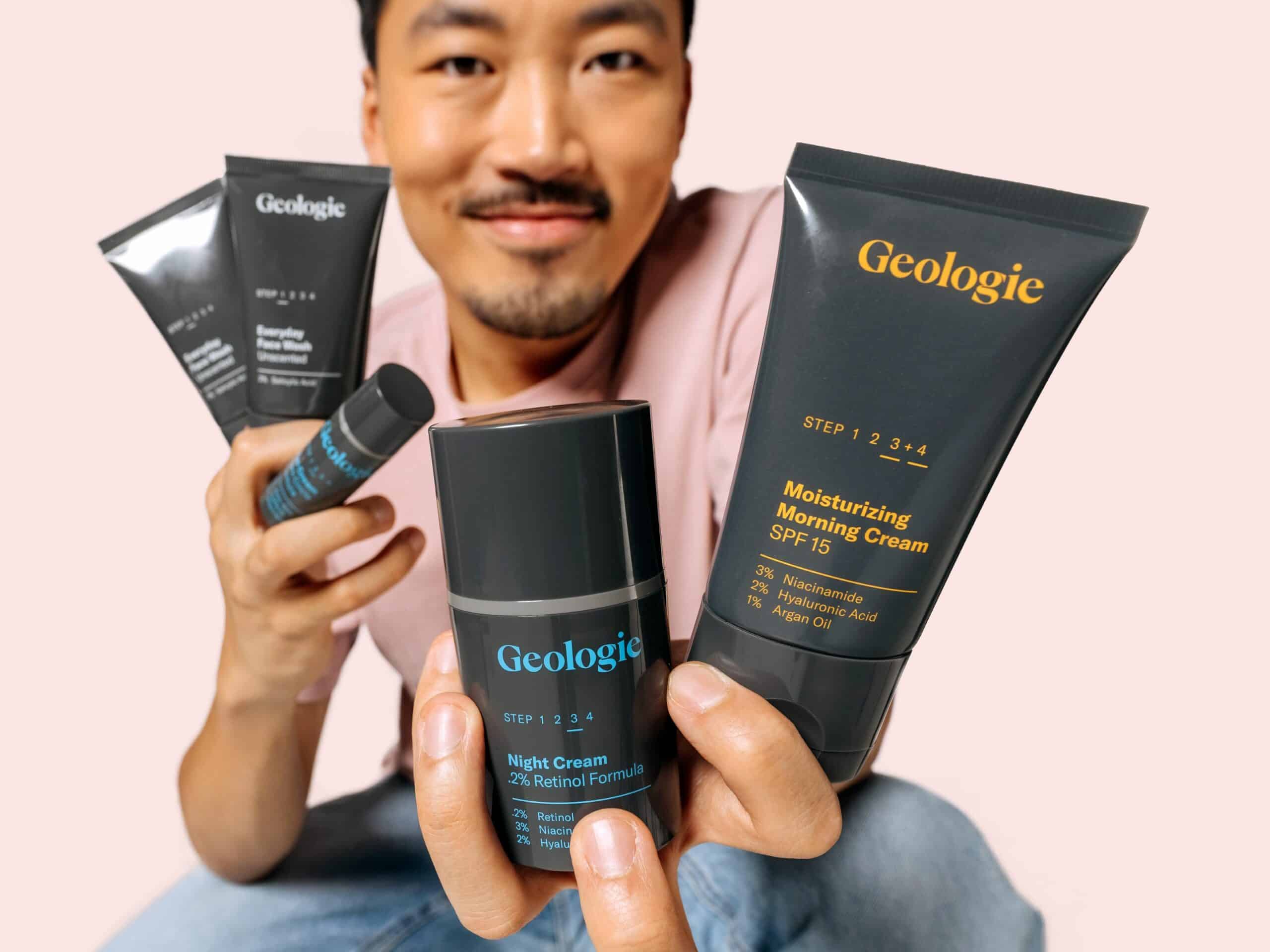 model holding up Geologie skincare, pink background