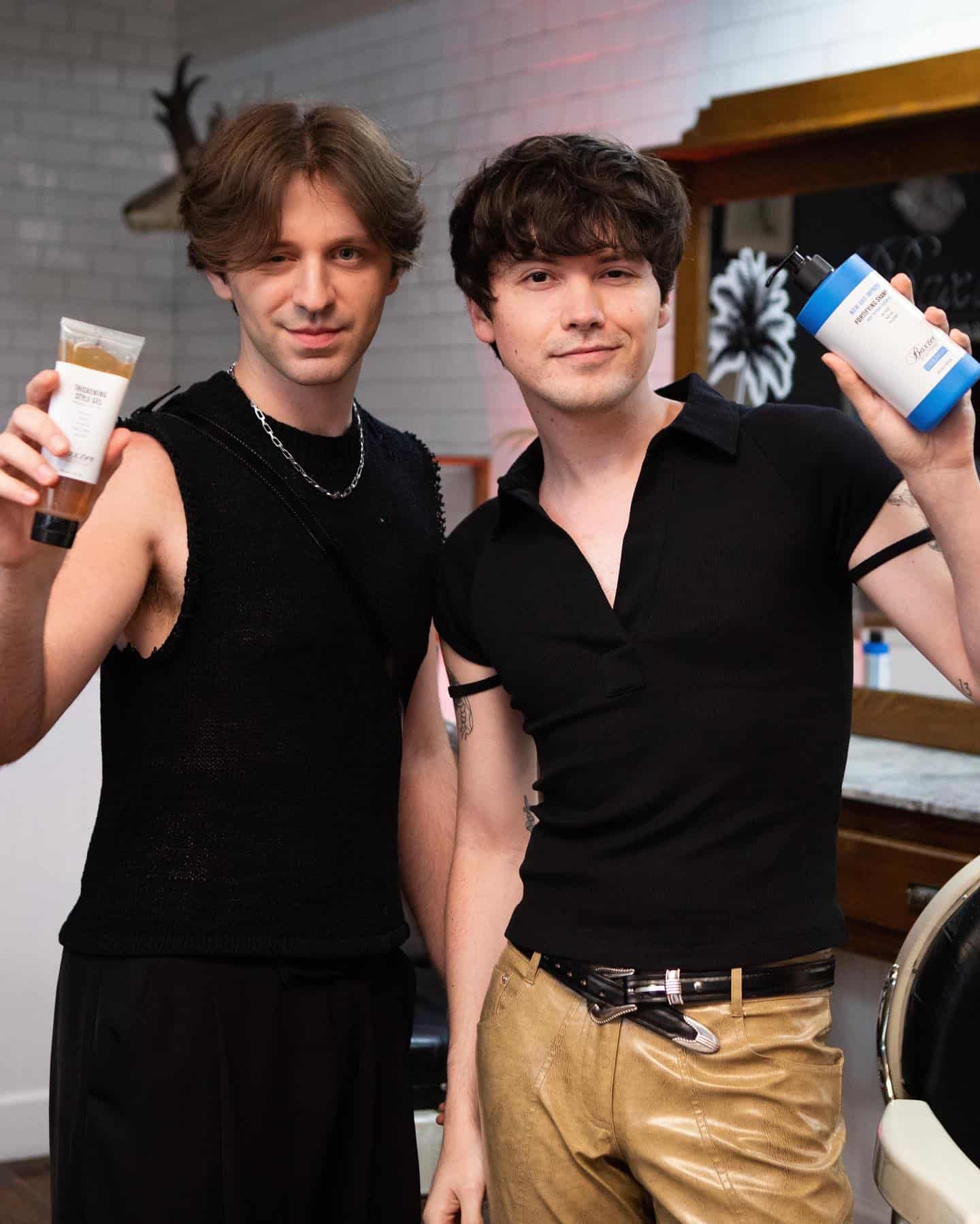 two men holding hair care essentials by baxter of california