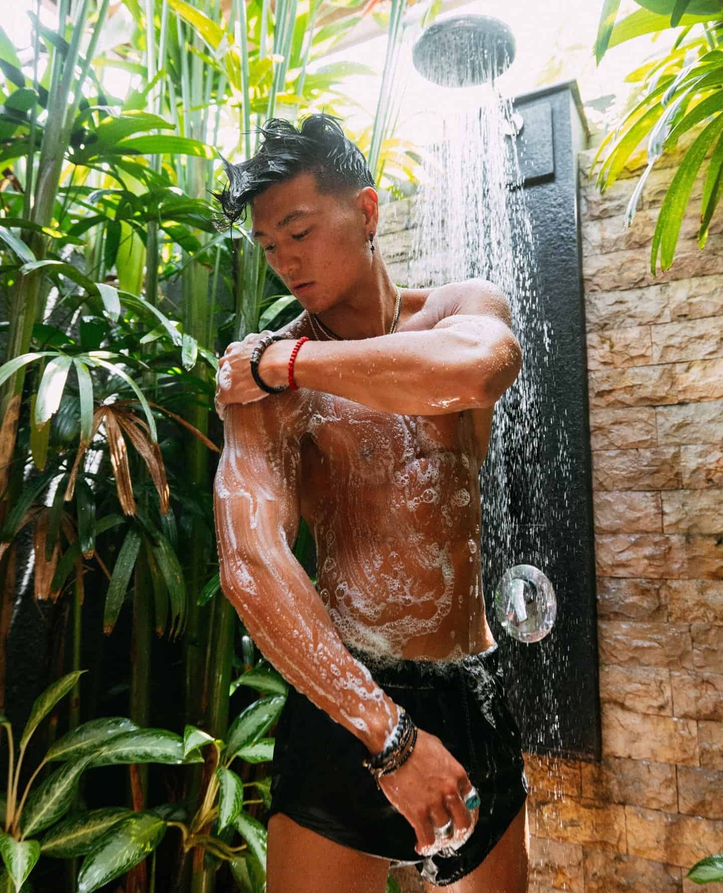 man applying soap on body