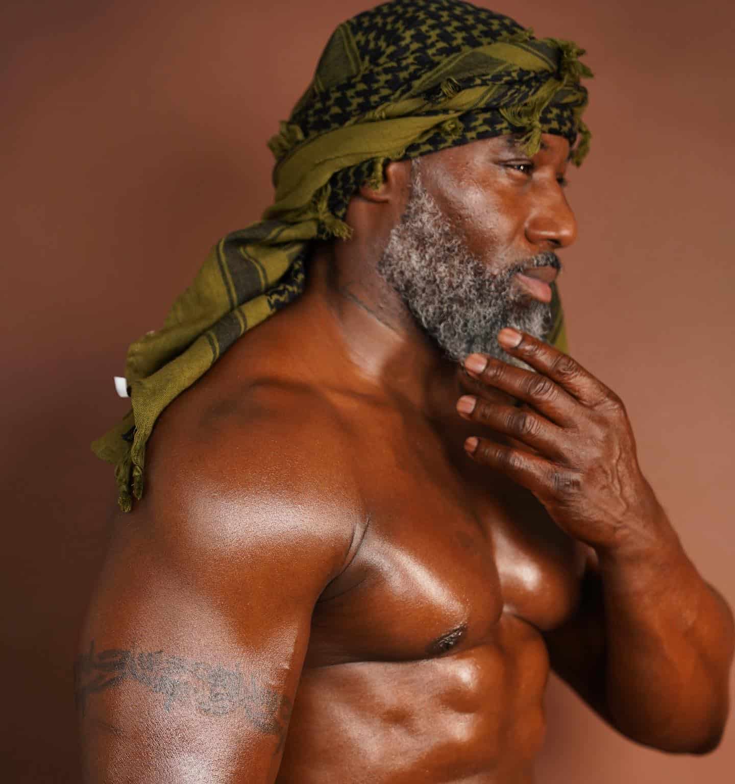 man in a turban holding his beard