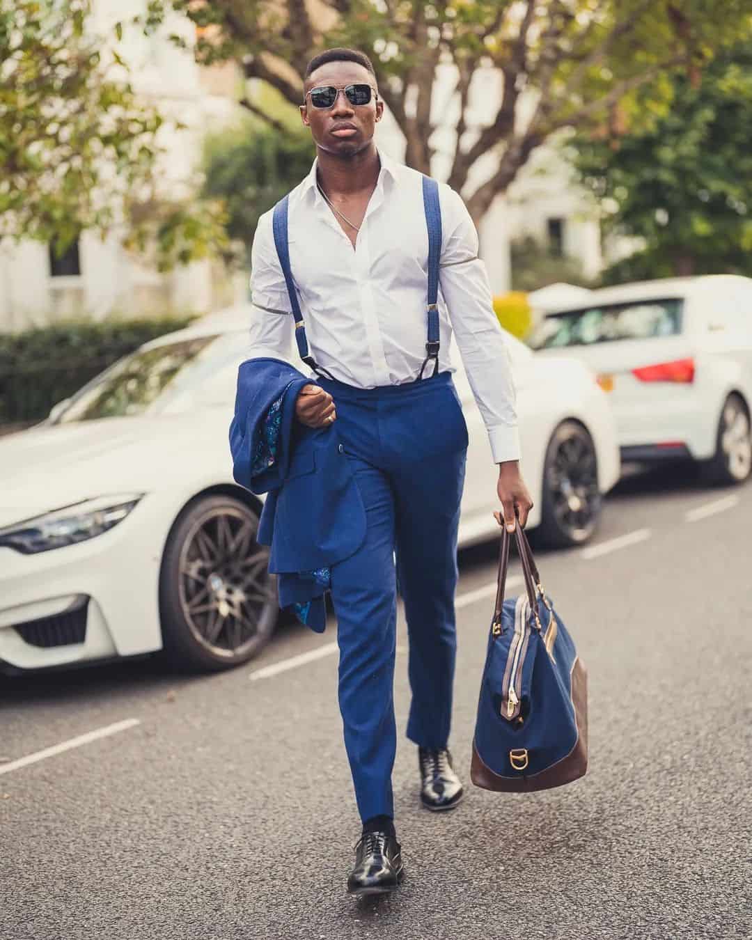 man carrying a blazer and weekender bag