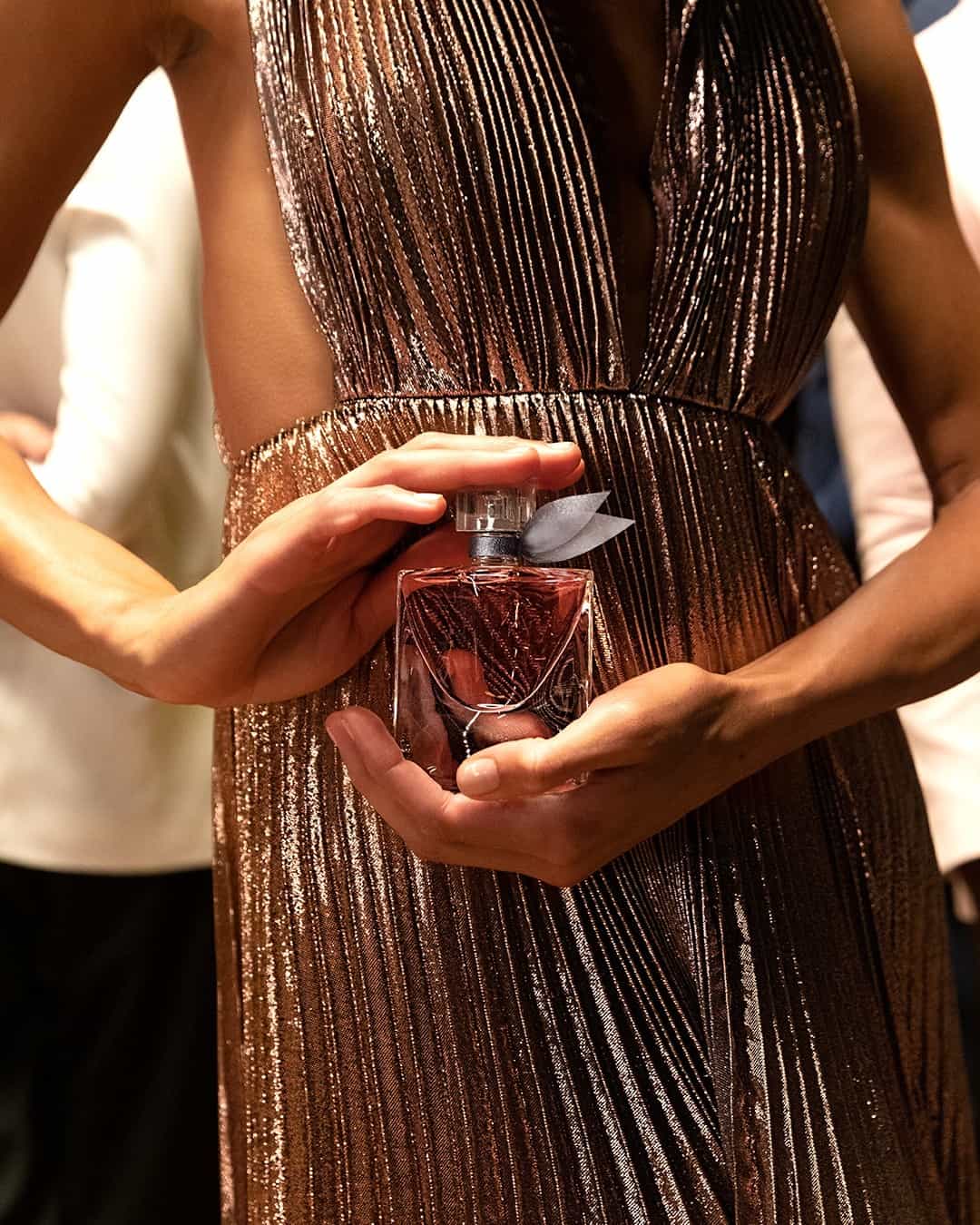 woman holding a bottle of Lancôme La Vie Est Belle