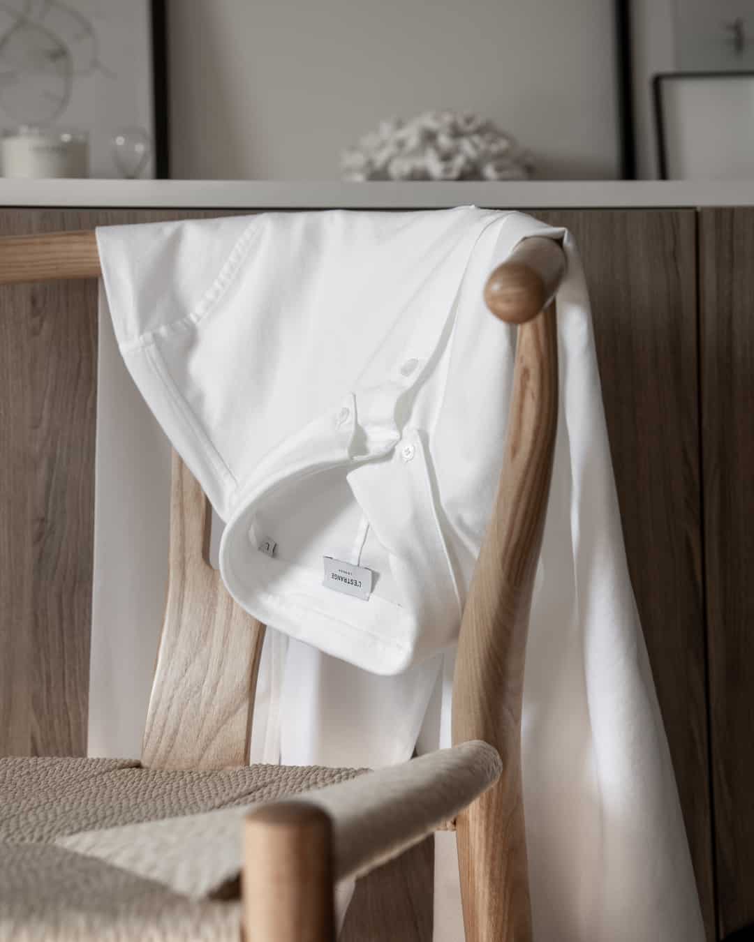 white shirt hanging on a chair
