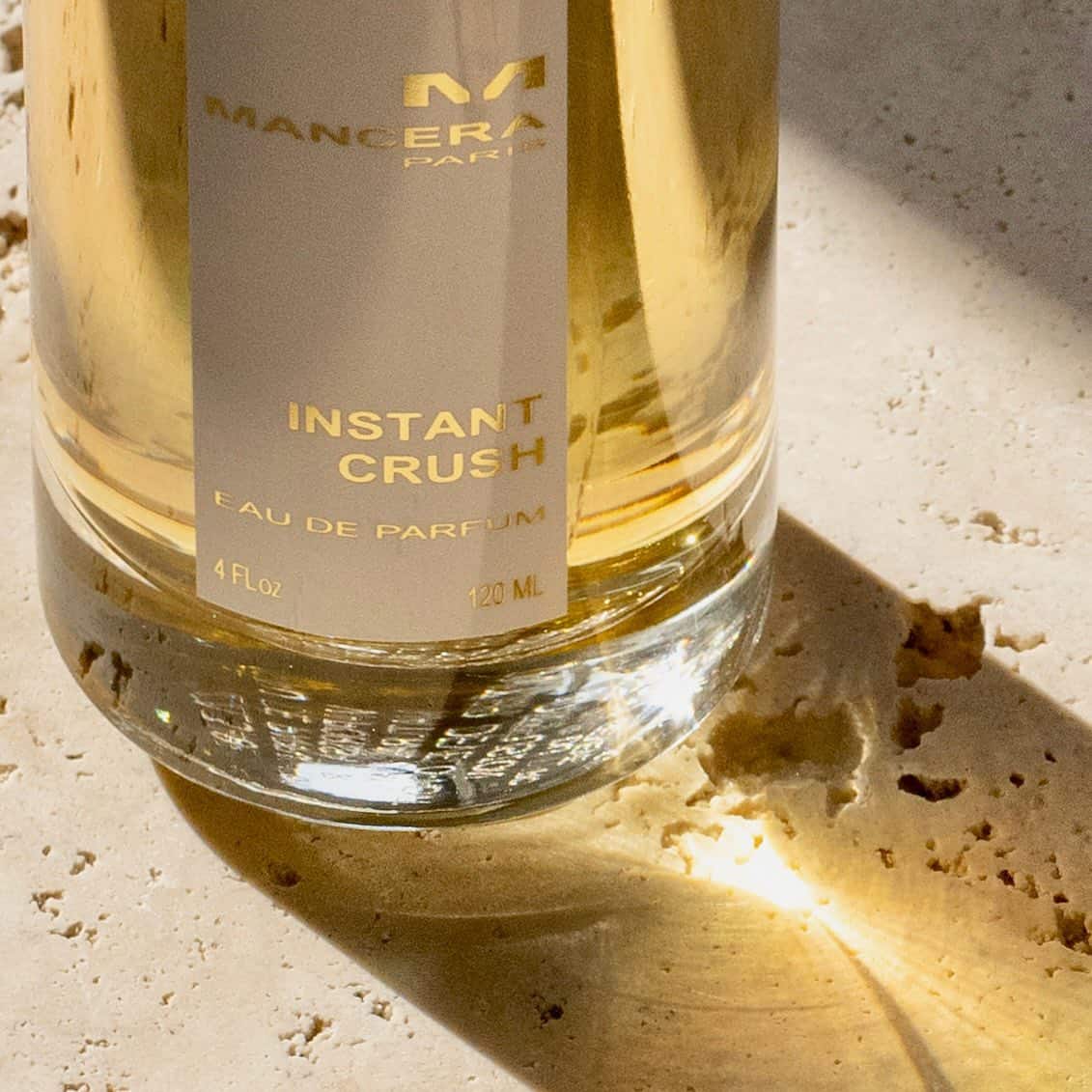 a bottle of mancera instant crush casting a shadow
