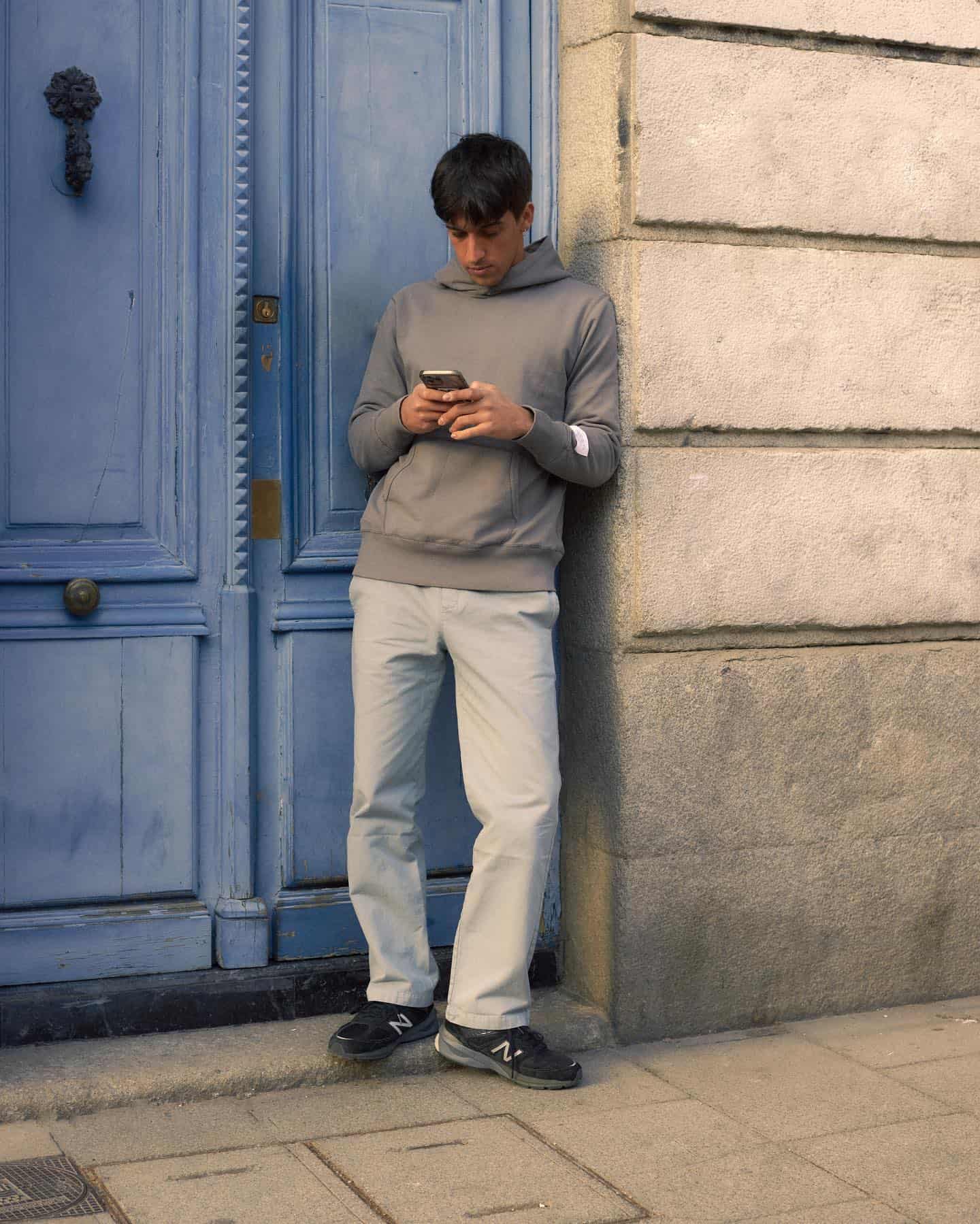 man standing by a blue door