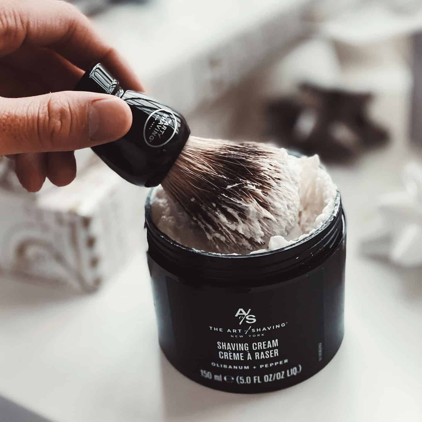 dipping a brush into a shaving cream