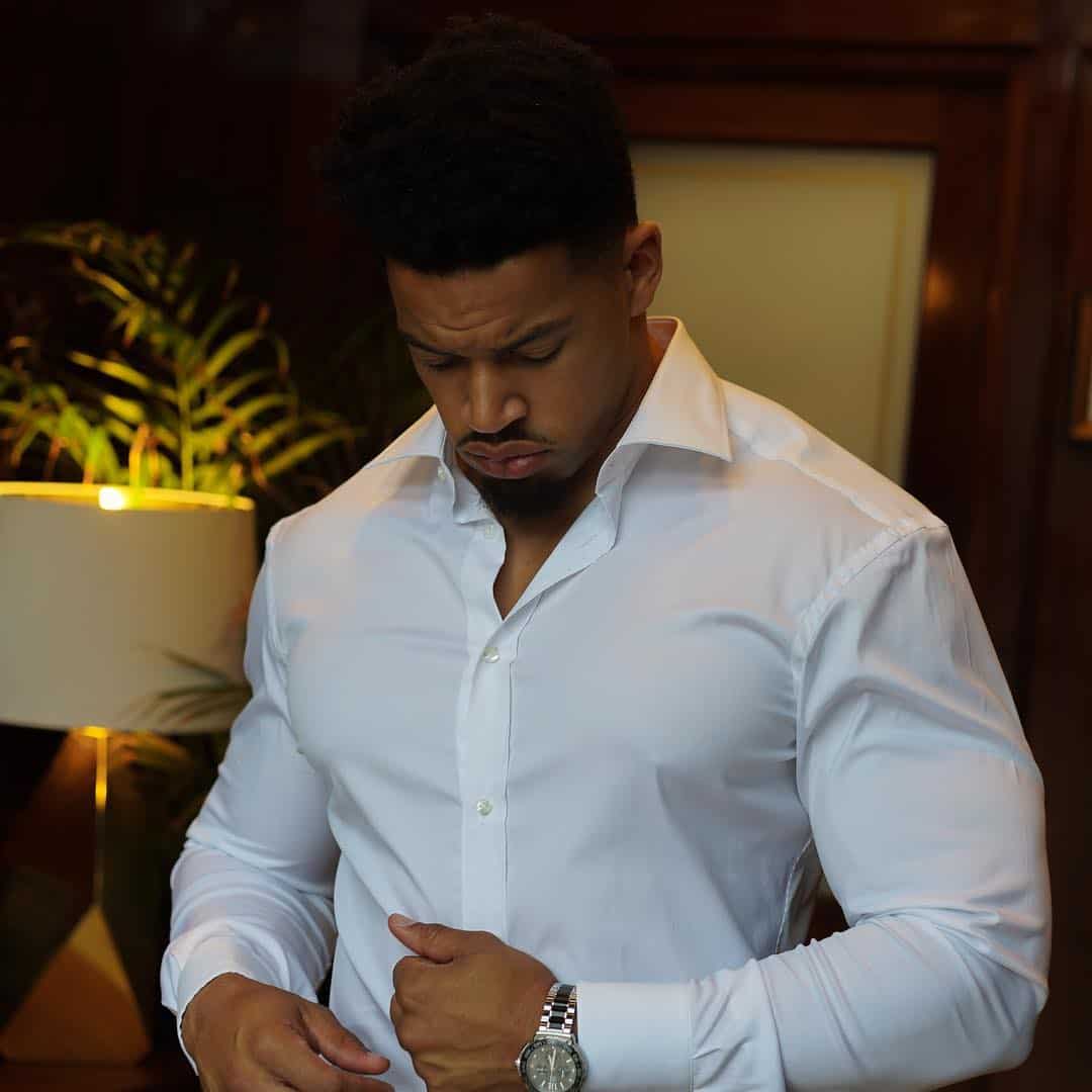 man checking his white shirt