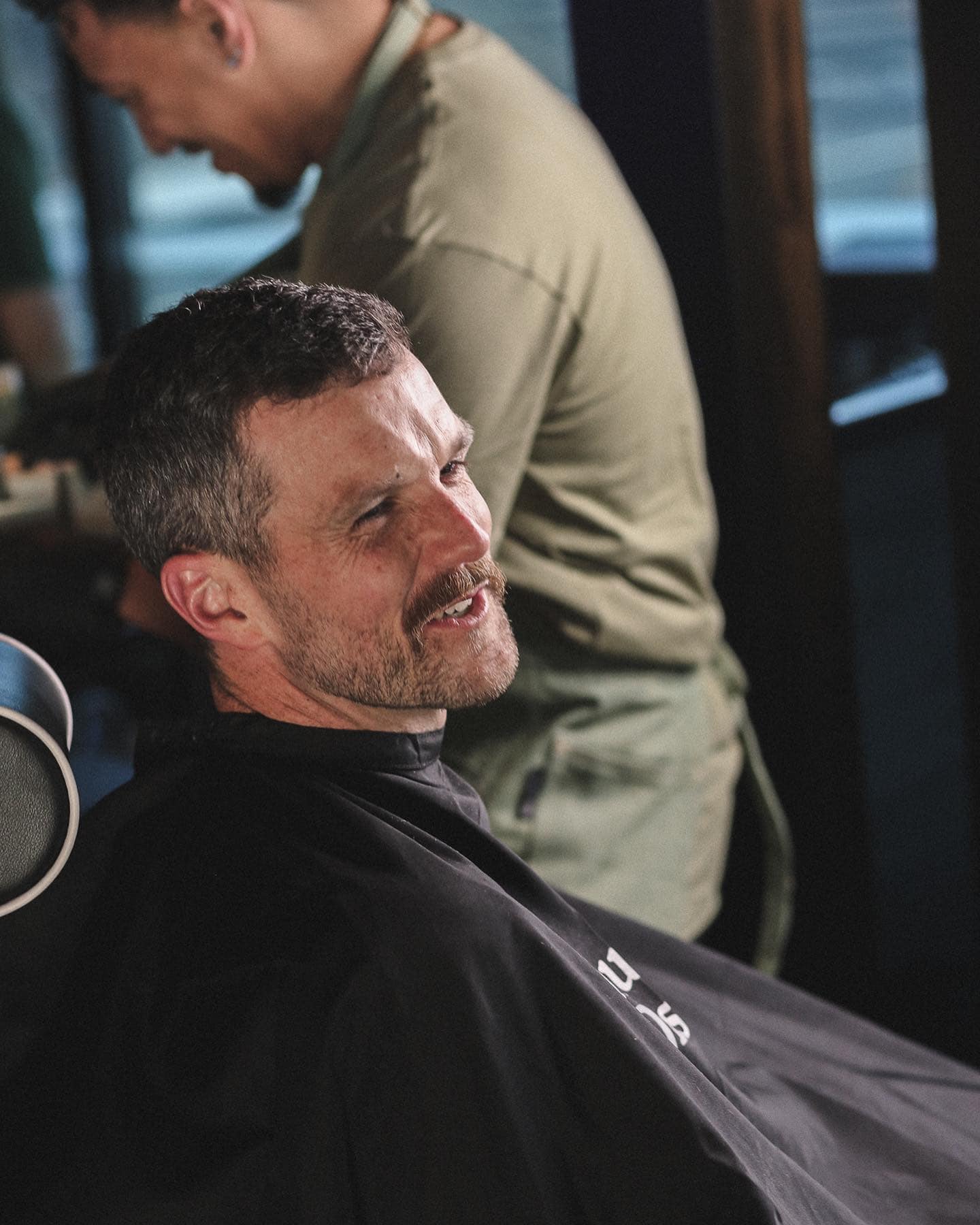 man sitting in a barber's chair