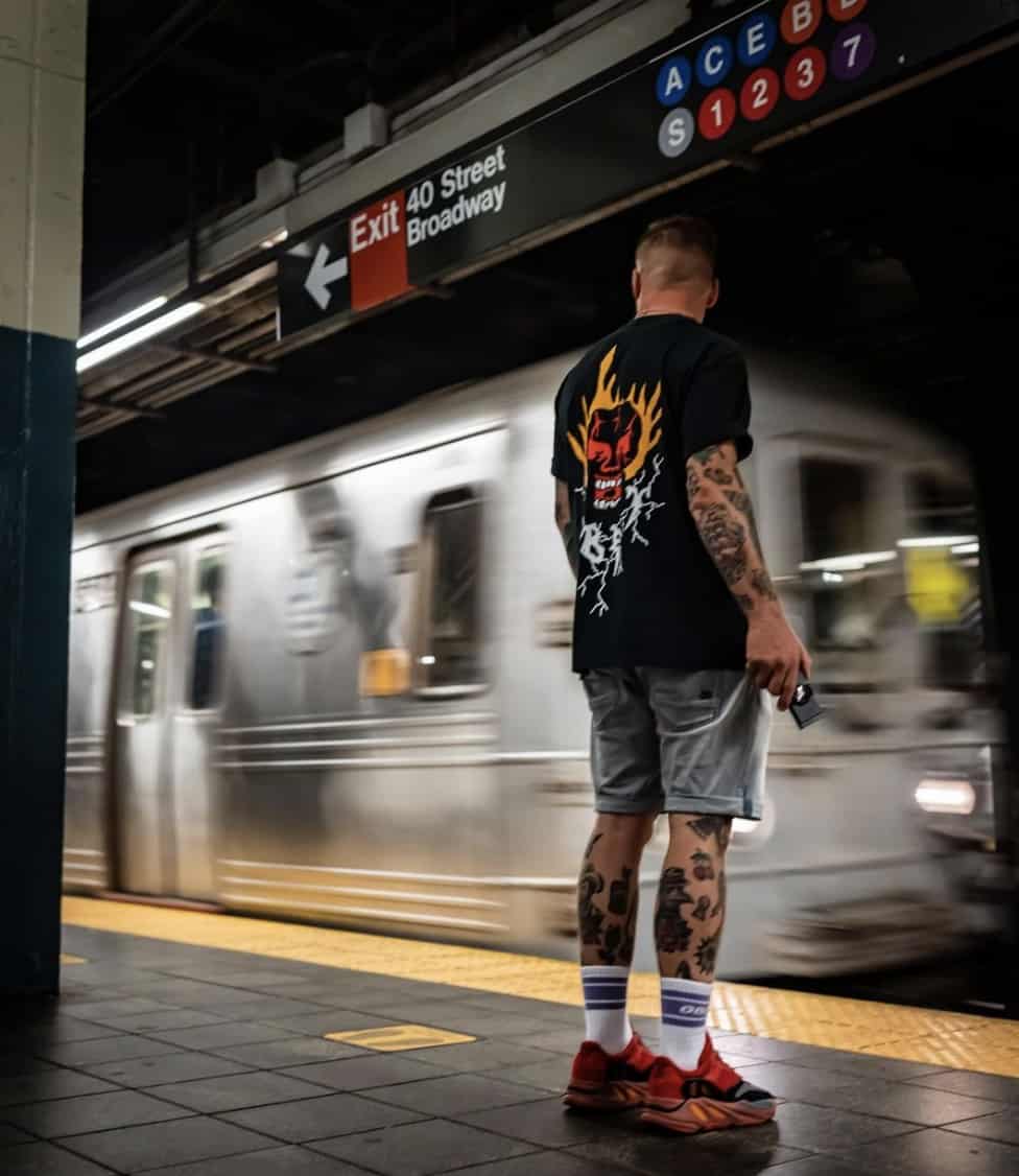 Man at a subway station holding an ekster wallet