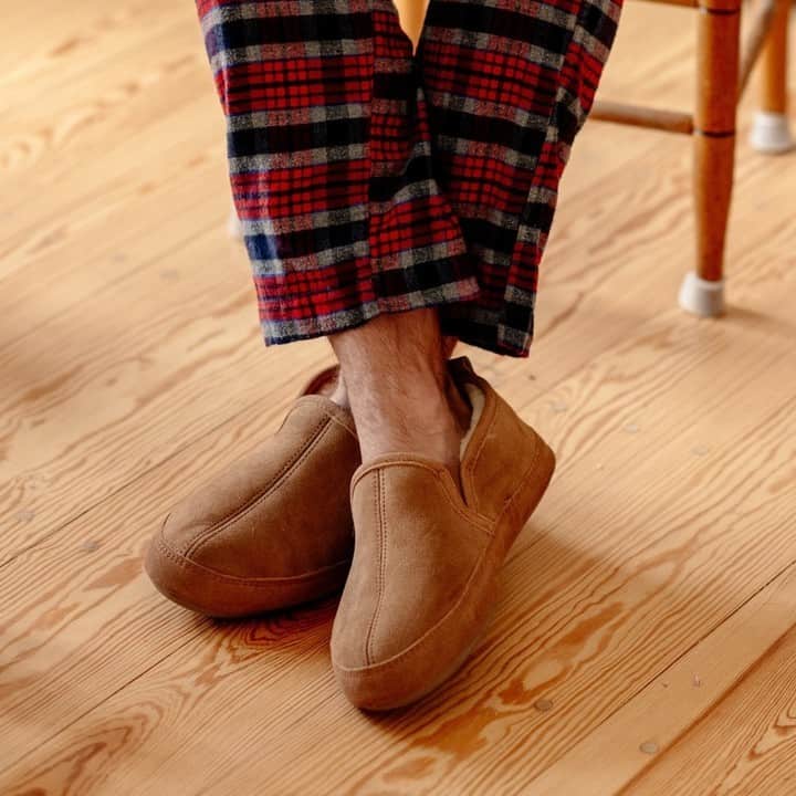 wearing a pair of comfy sheepskin slippers by acorn