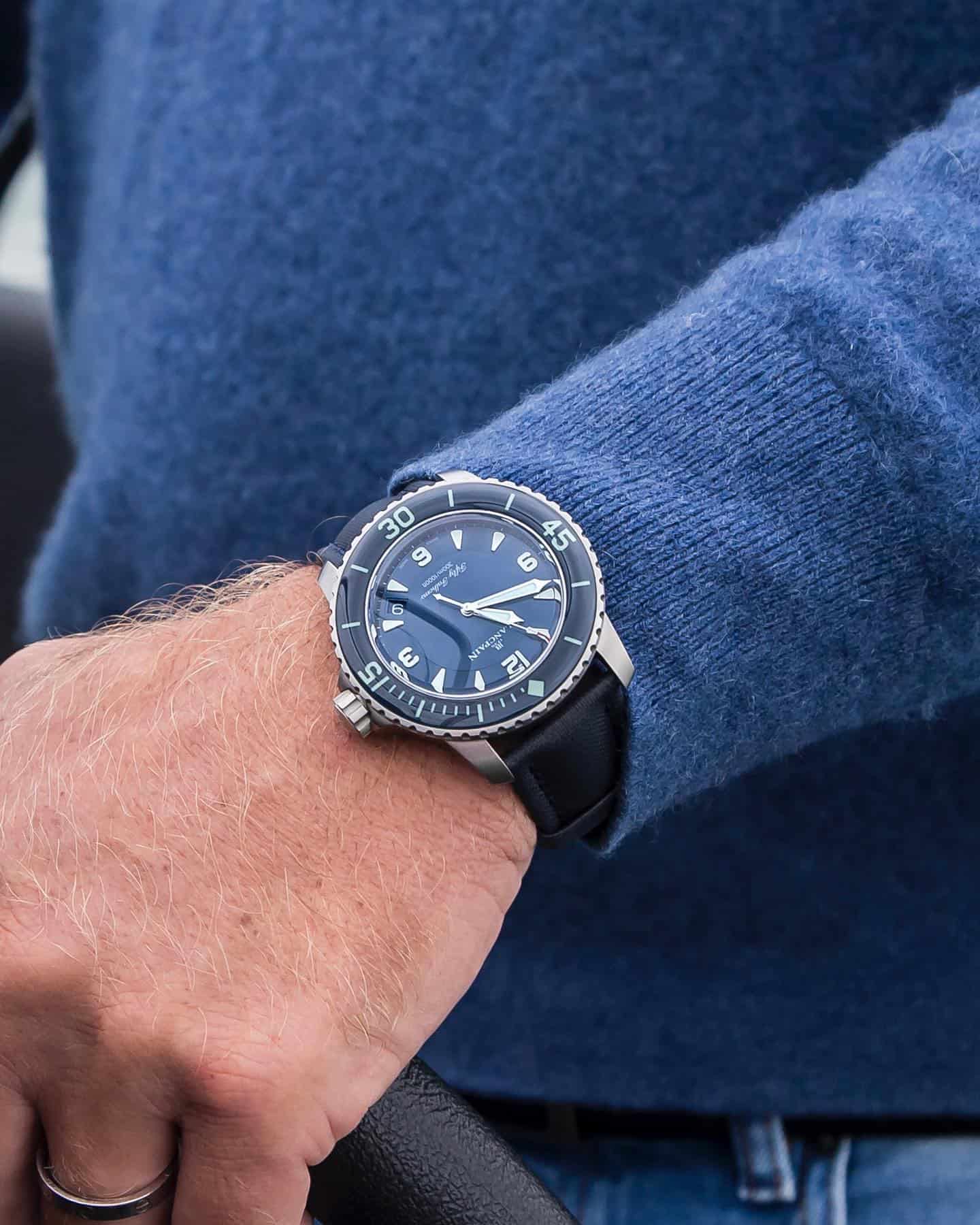man wearing the fifty fathoms automatique by blancpain