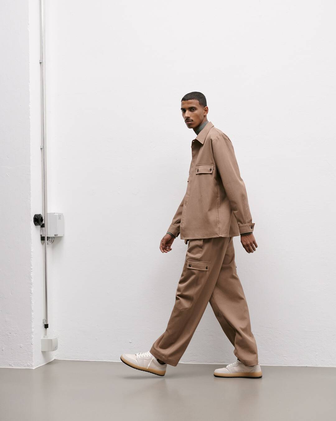 man wearing a brown pure cotton overshirt by closed