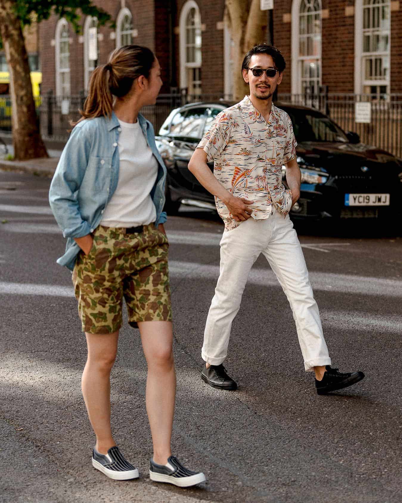 man walking behind a woman on the street
