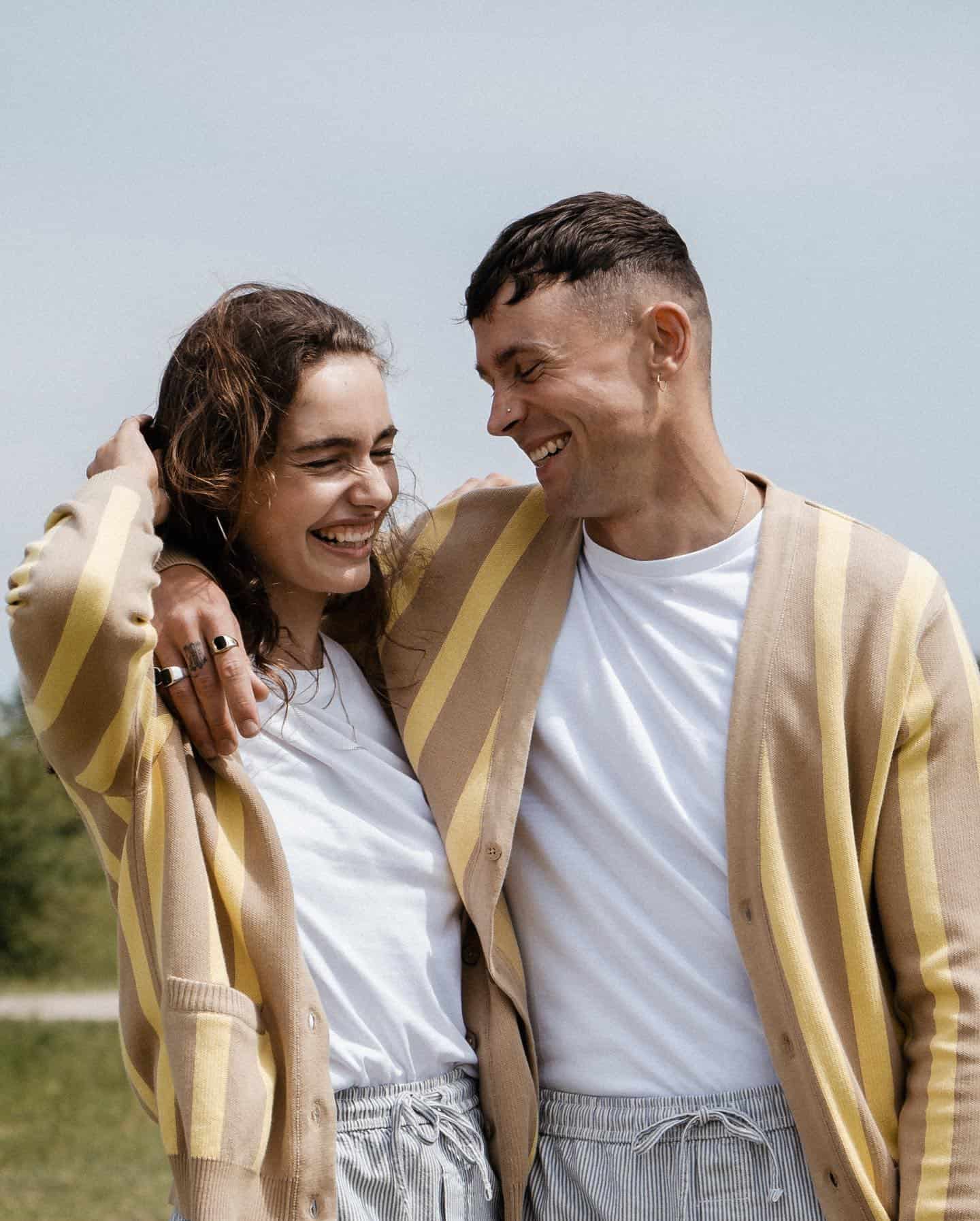 man with arms around woman's shoulder