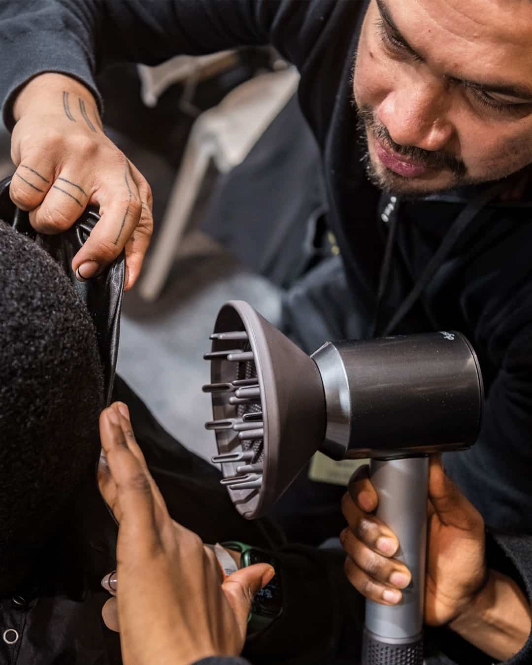 professional hair dresser using a dyson hair dryer