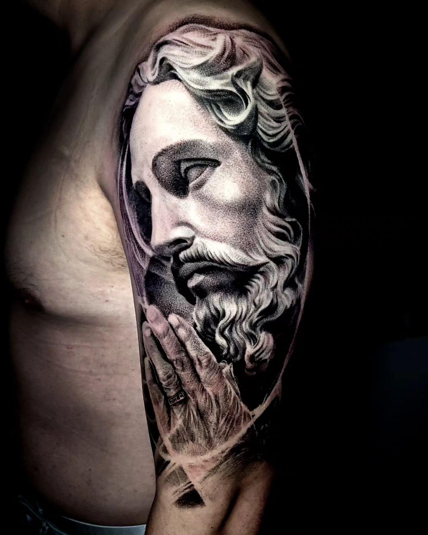 religious tattoo on left arm