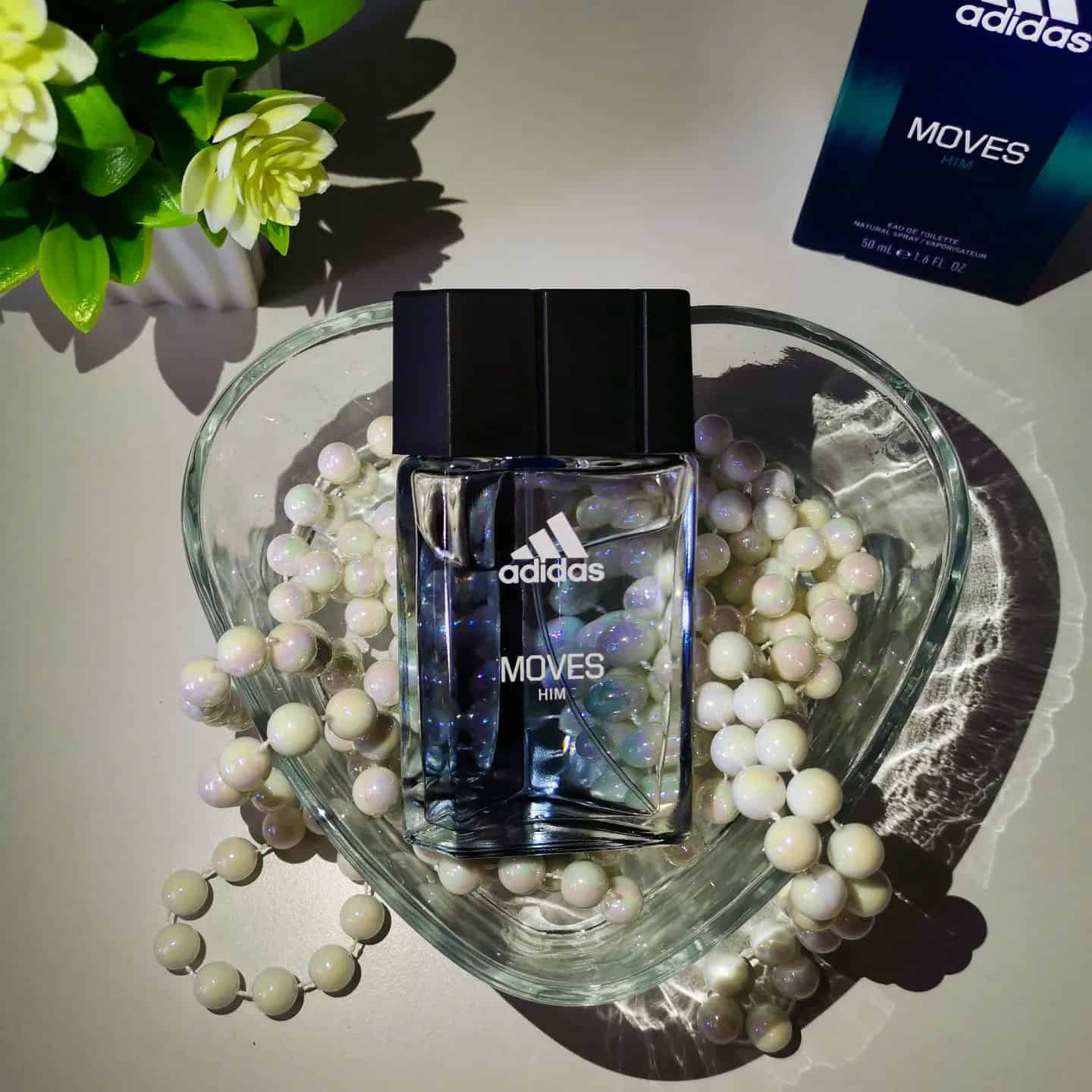 a bottle of adidas moves for him in a tray of beads