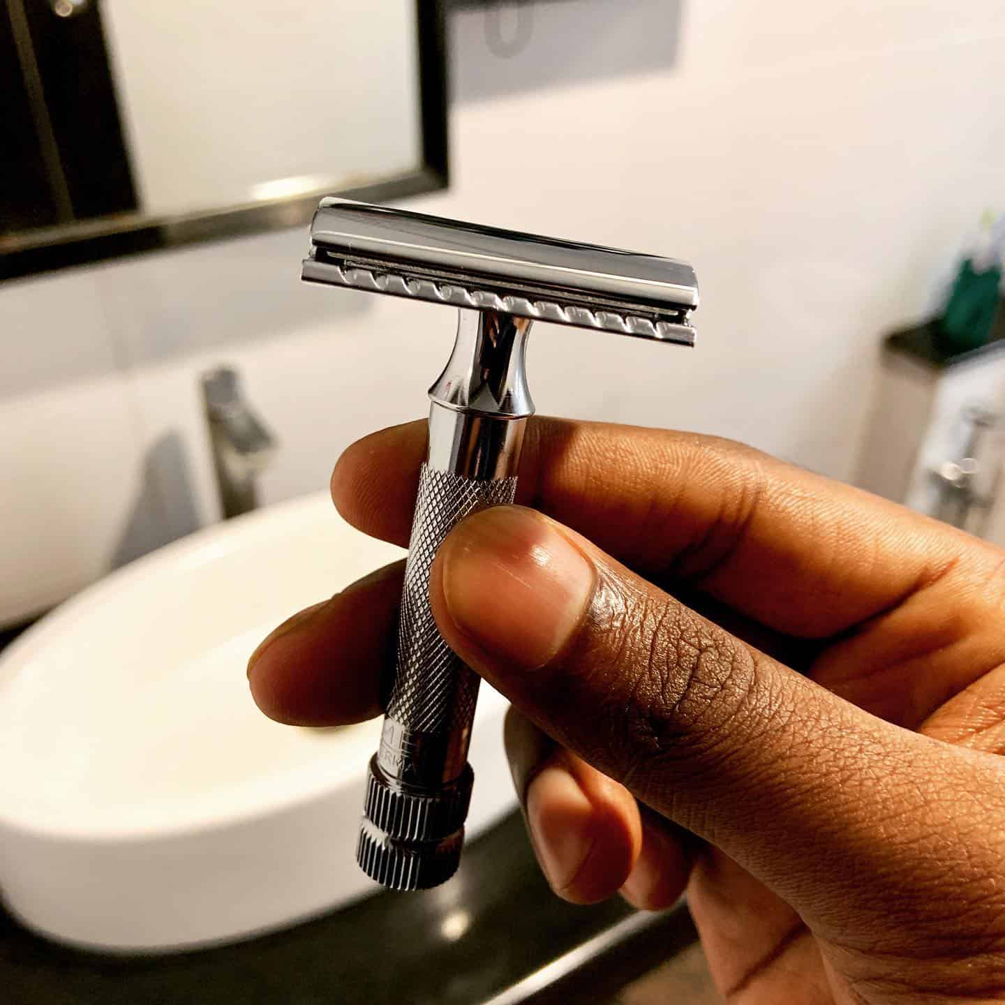 man holding a classic merkur razor