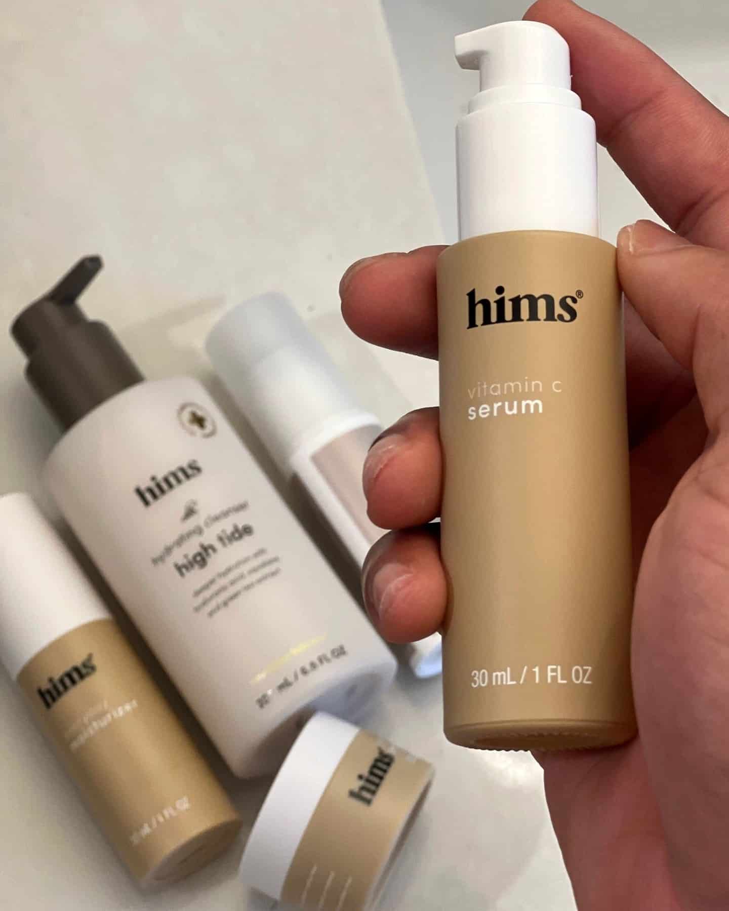 holding a bottle of hims vitamin c serum