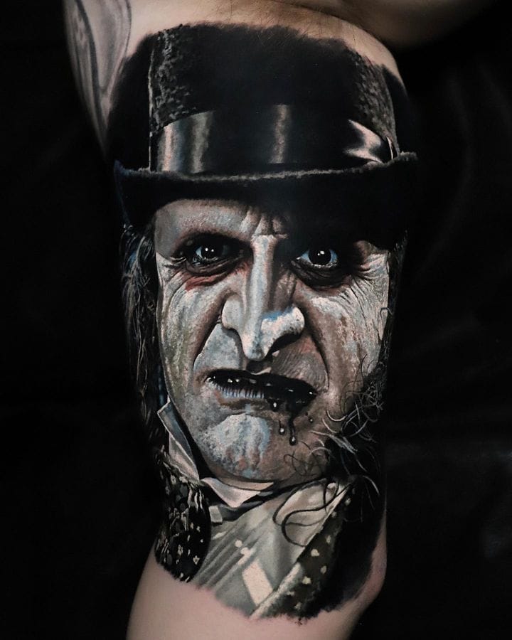 the penguin tattooed on arm