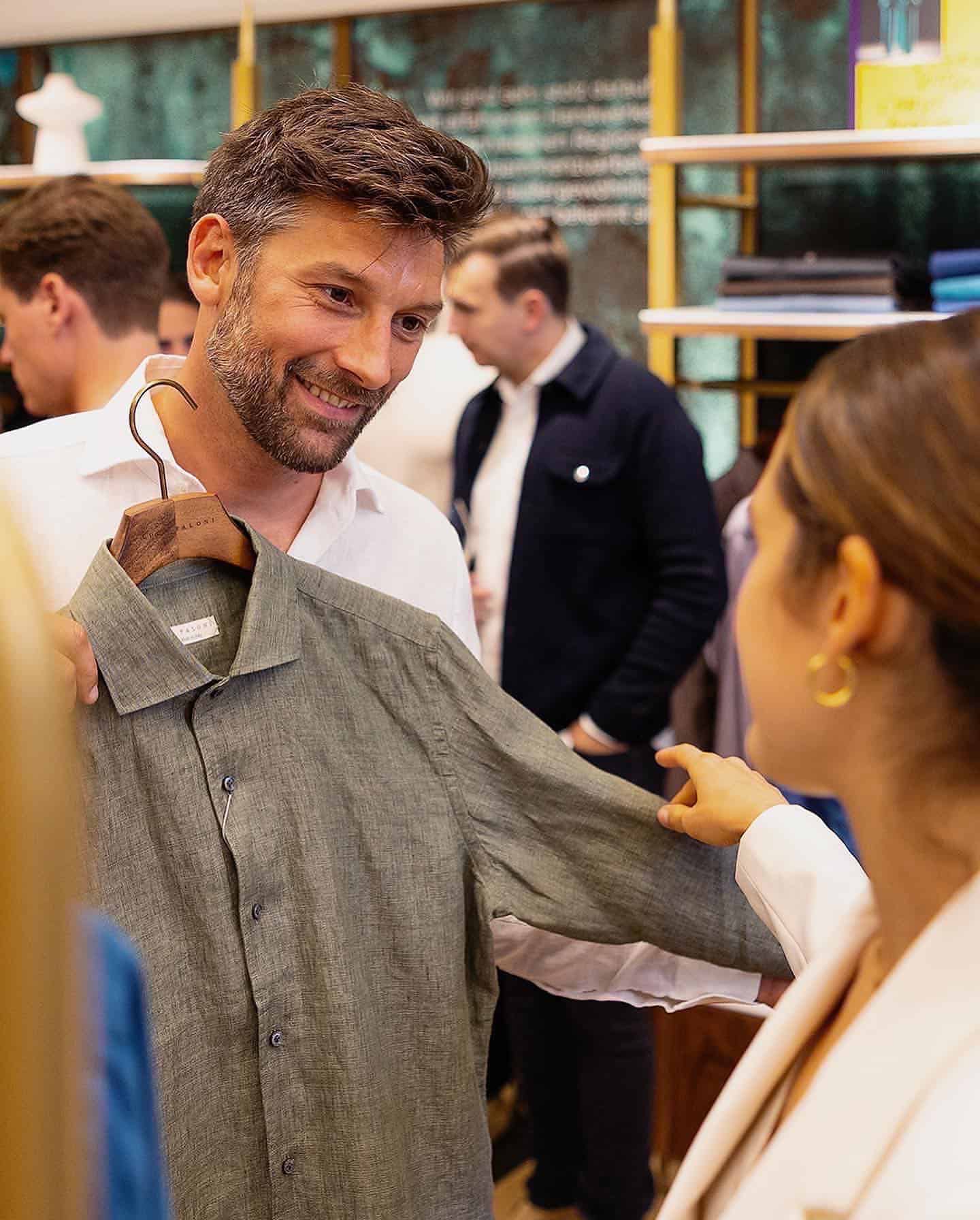 man showing a shirt to a woman