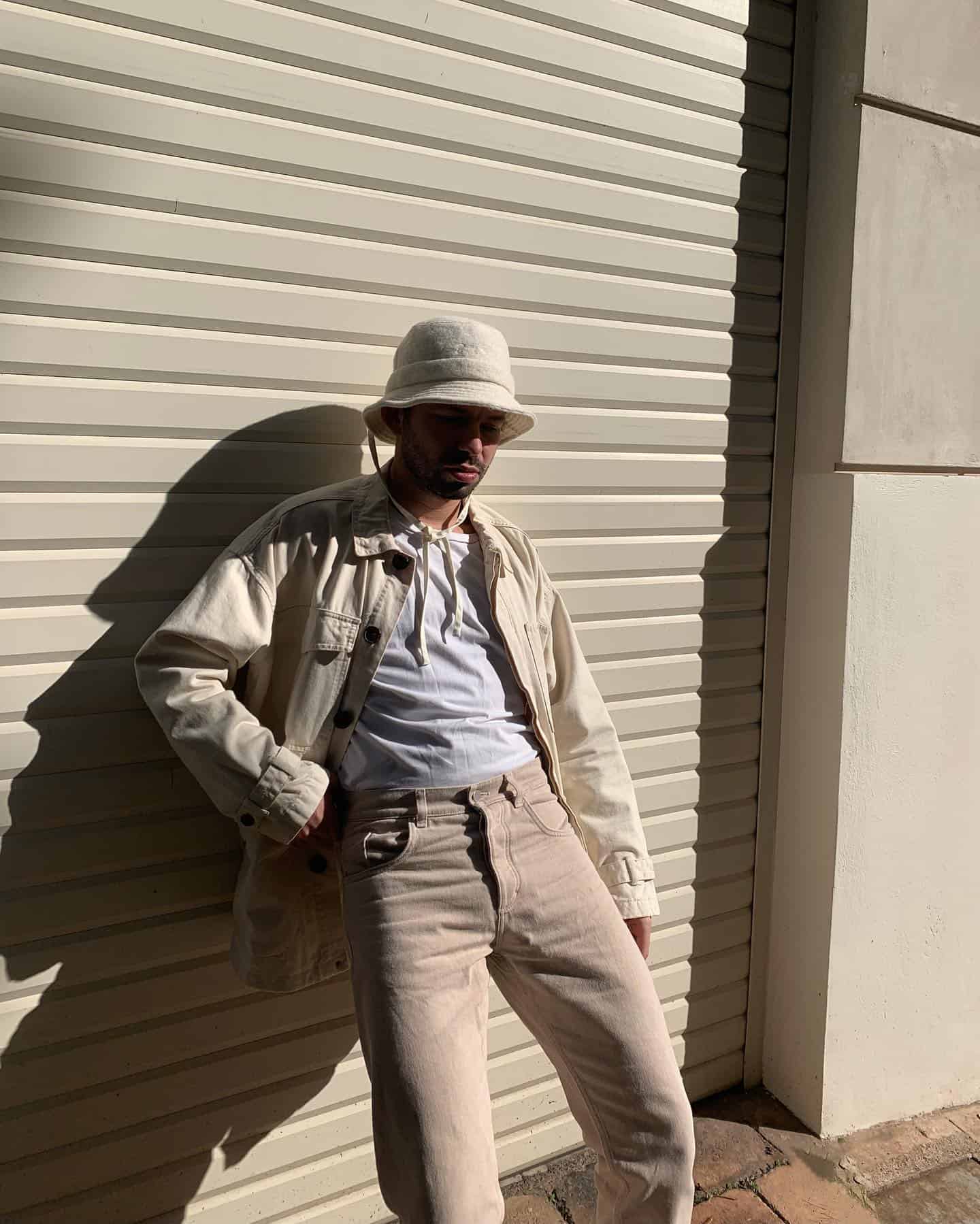 man in an off-white outfit