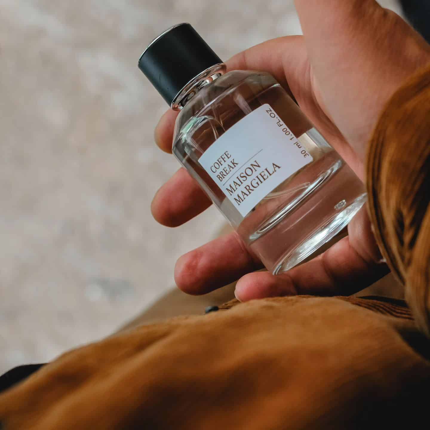 carrying a small bottle of coffee break by maison margiela