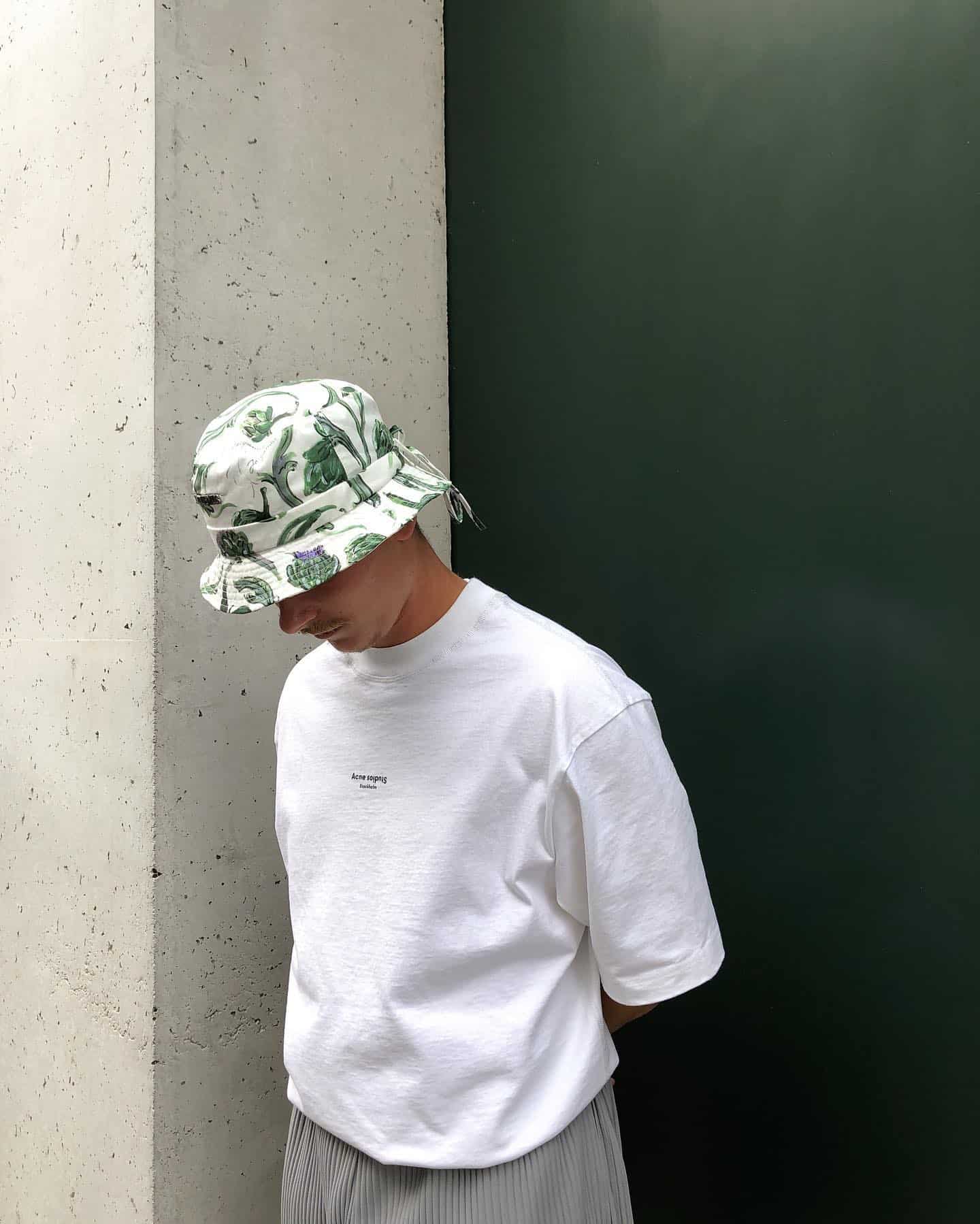 man in a leaf-printed bucket hat