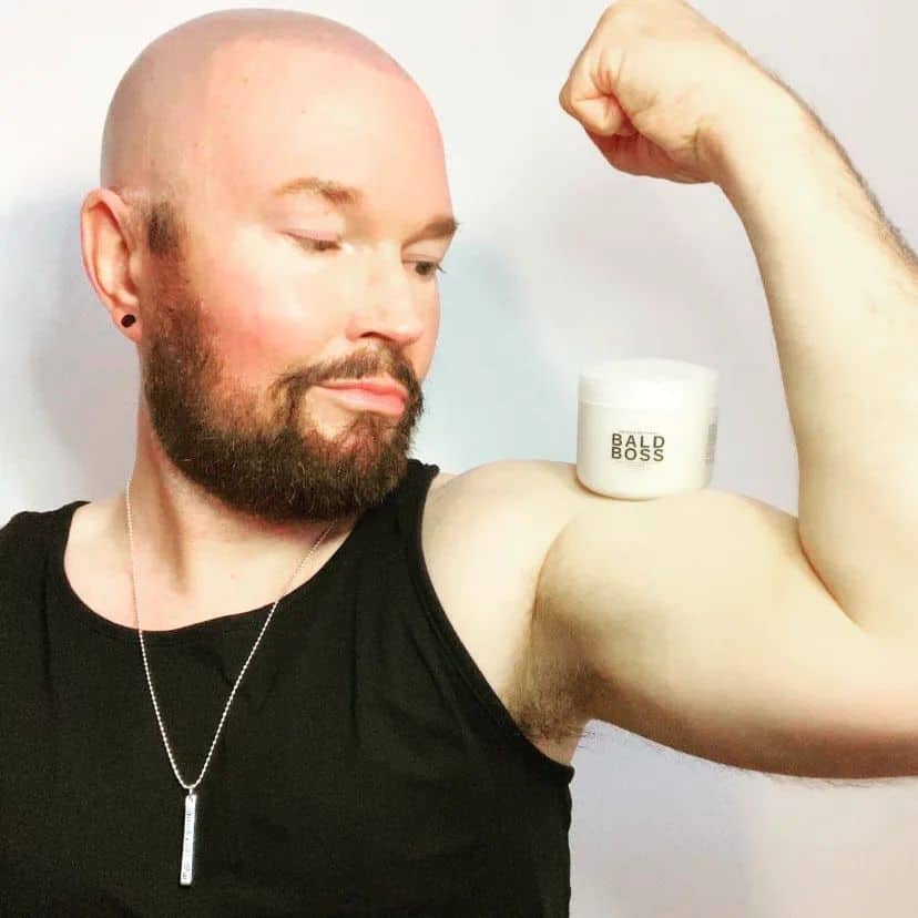bald man flexing his bicep