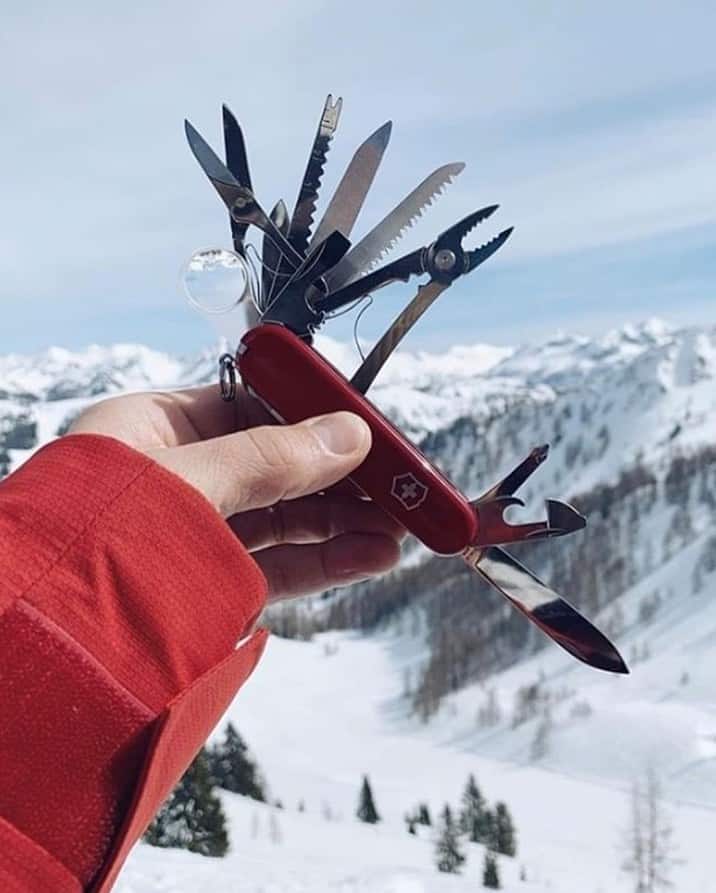 holding a swiss army knife by victorinox