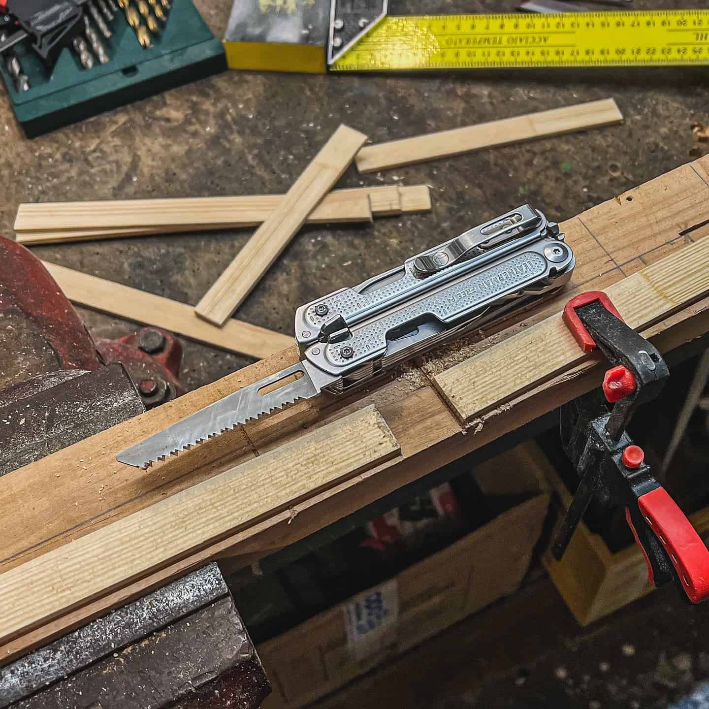 a leatherman multi tool on a wood board