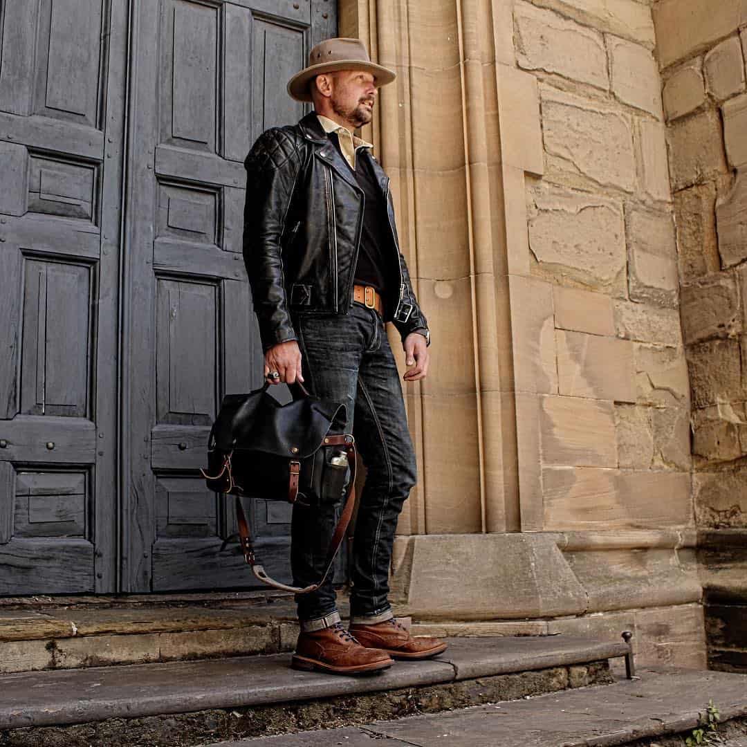man in cowboy hat and black leather jacket