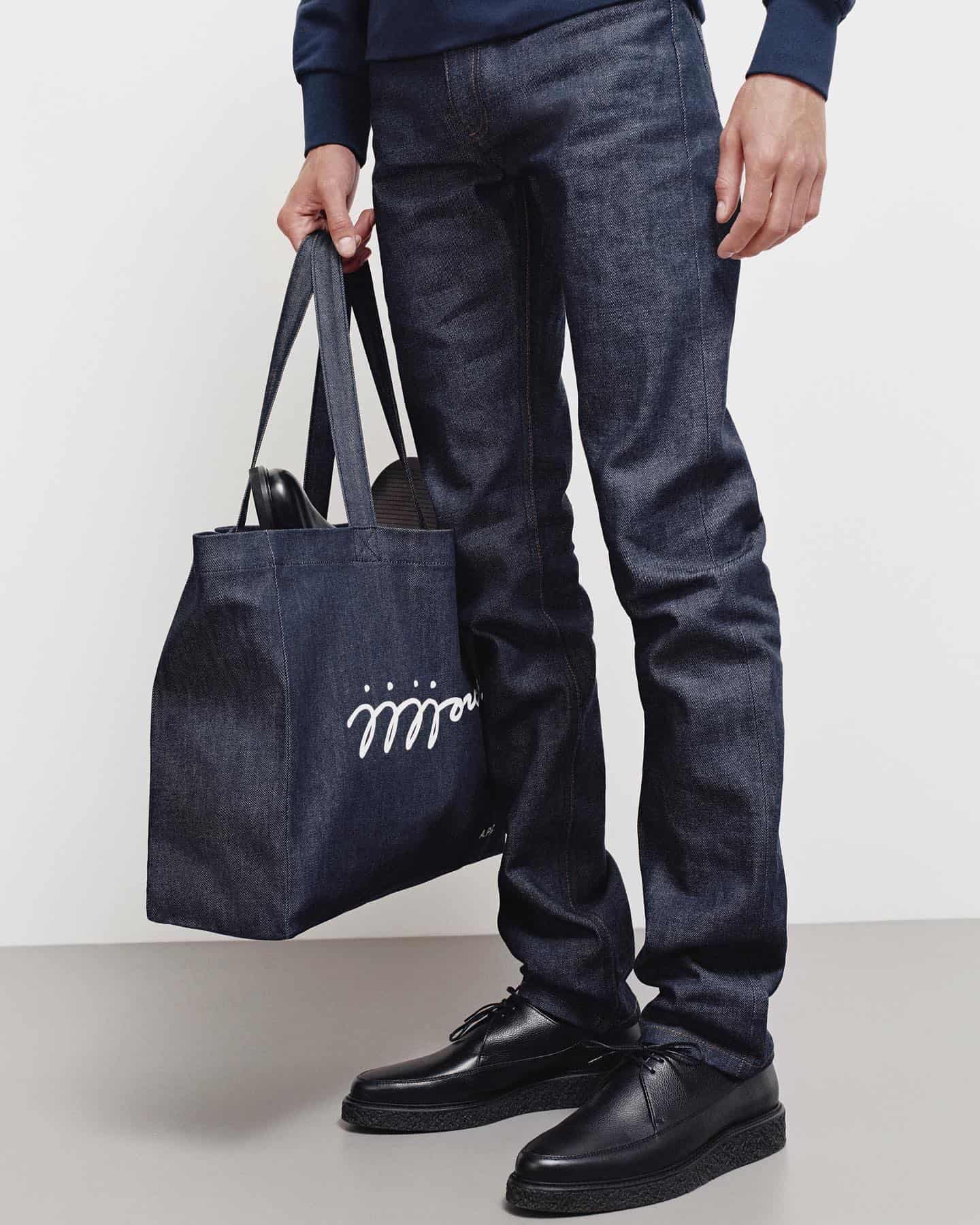man carrying a denim tote bag