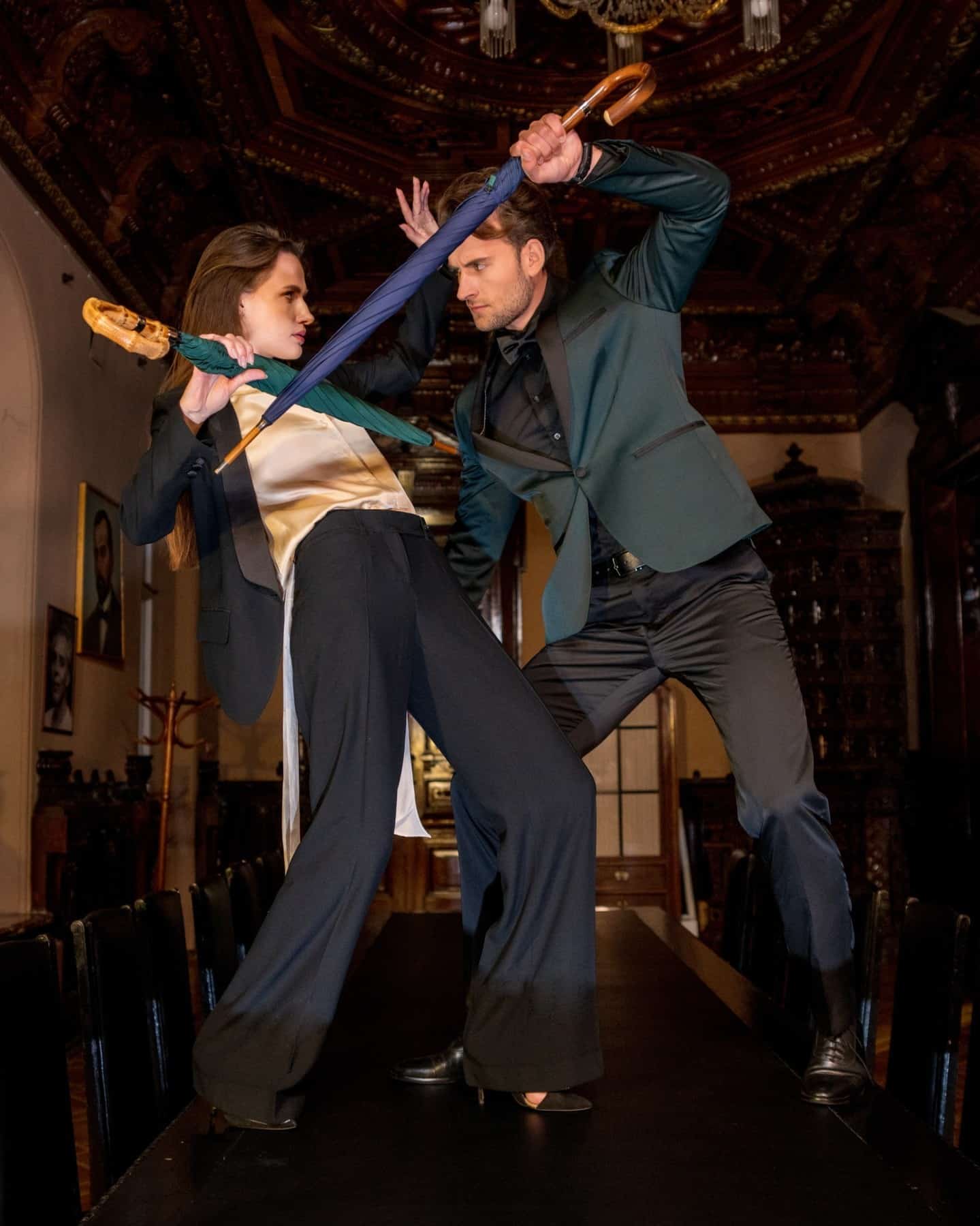 couples dueling with umbrellas on top of a table