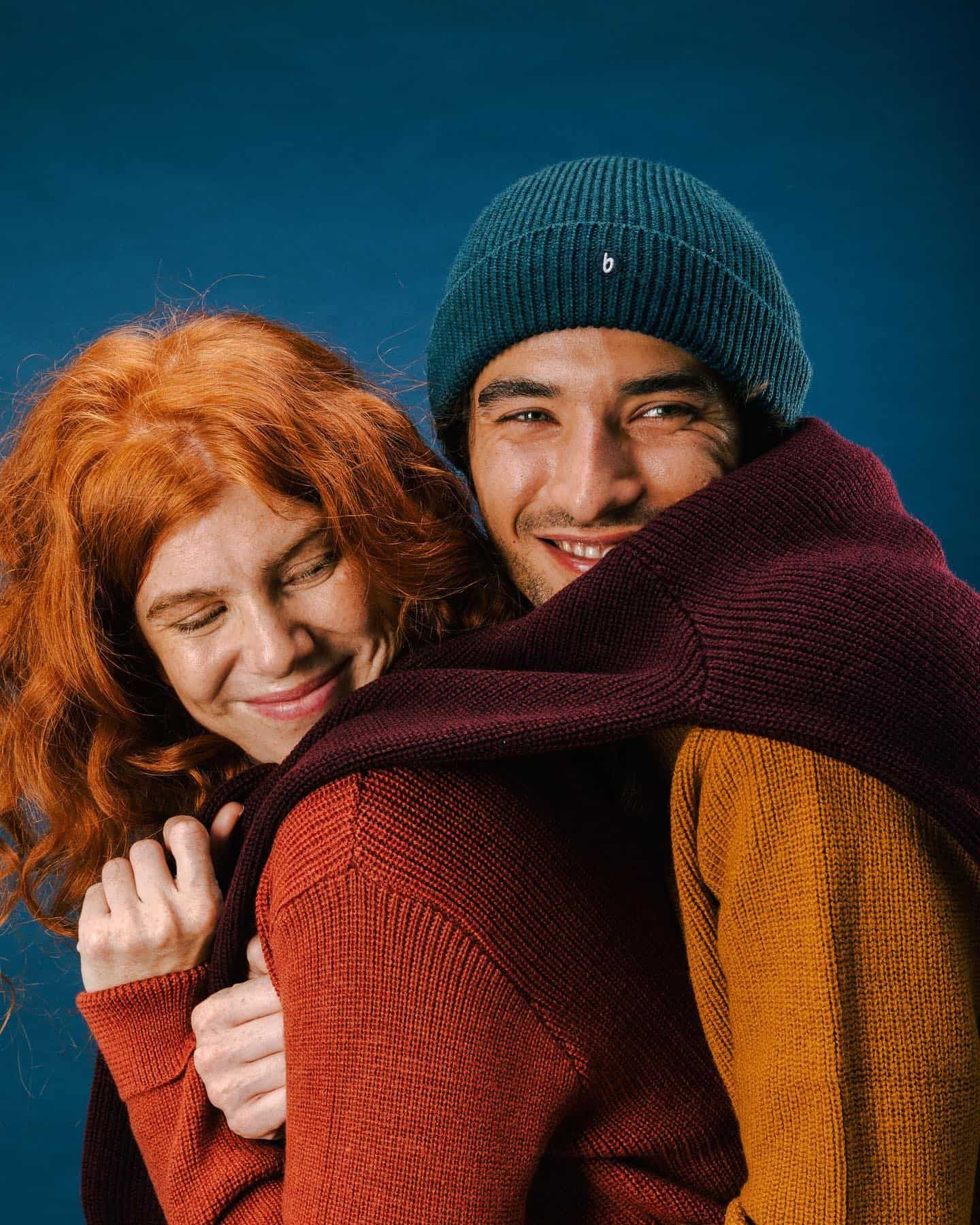 cuddling couple in sweaters