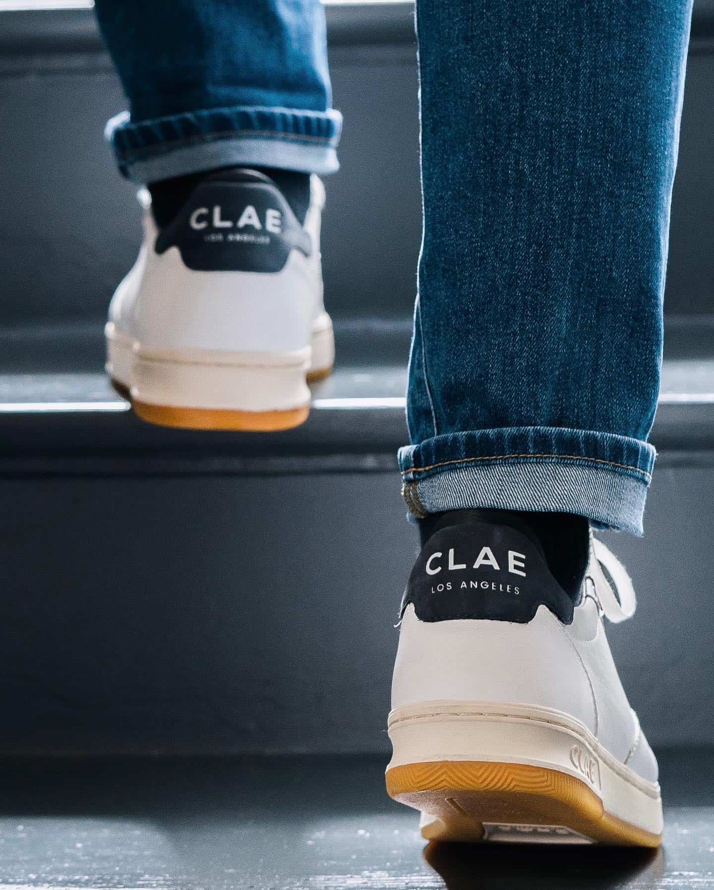 wearing a pair of white sneakers going up the stairs