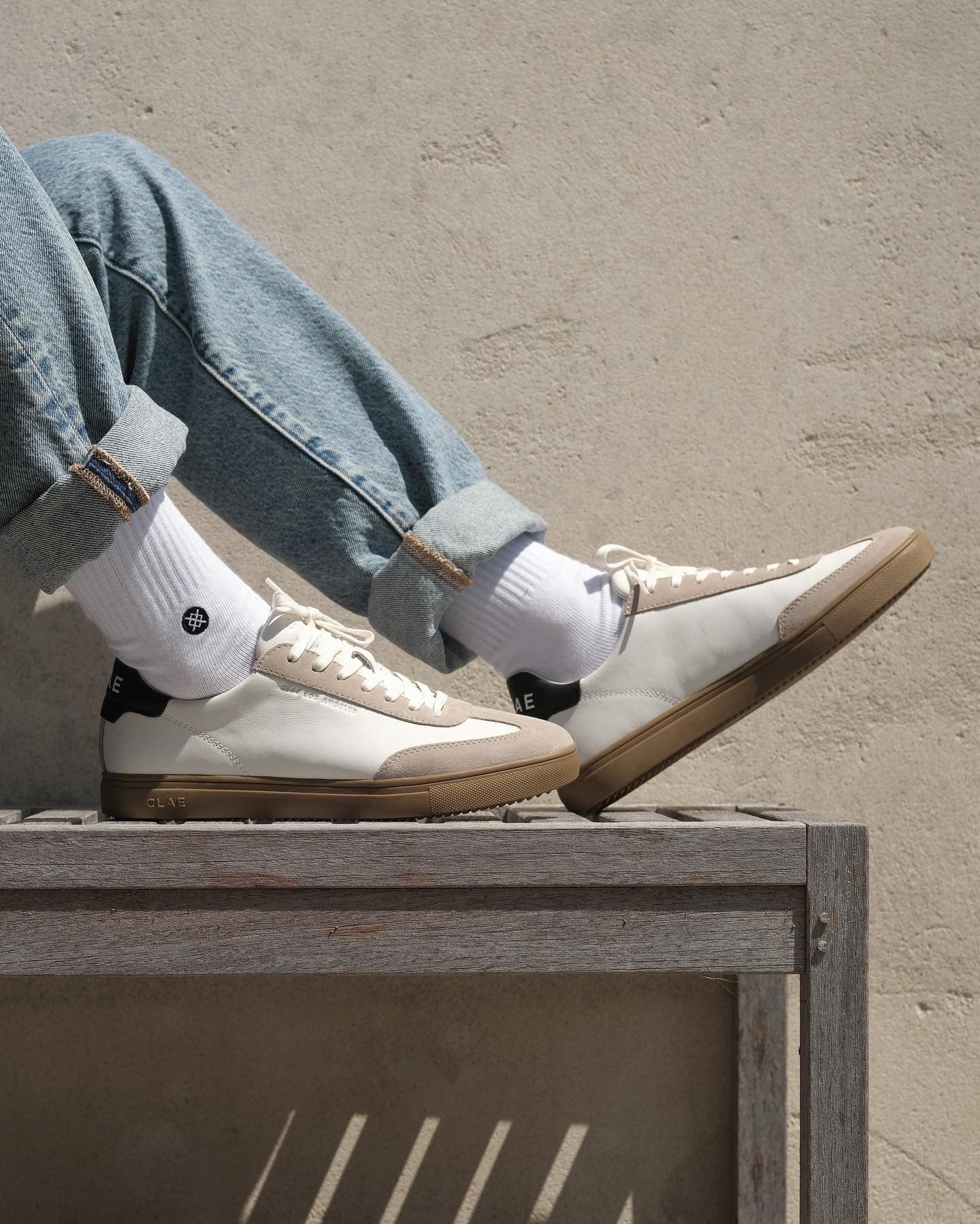 wearing a pair of white sneakers to a light wash jeans