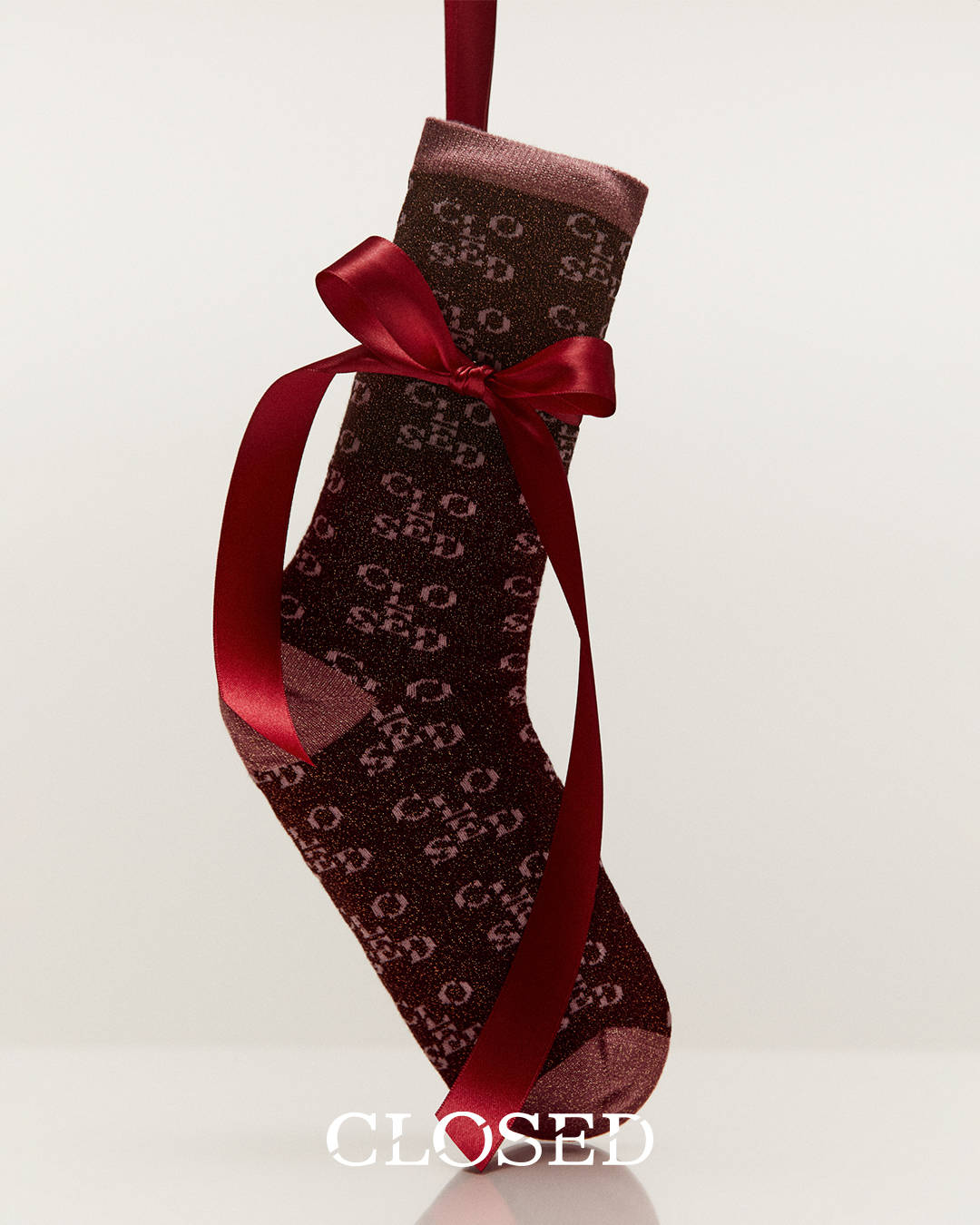 a sock tied with a red ribbon