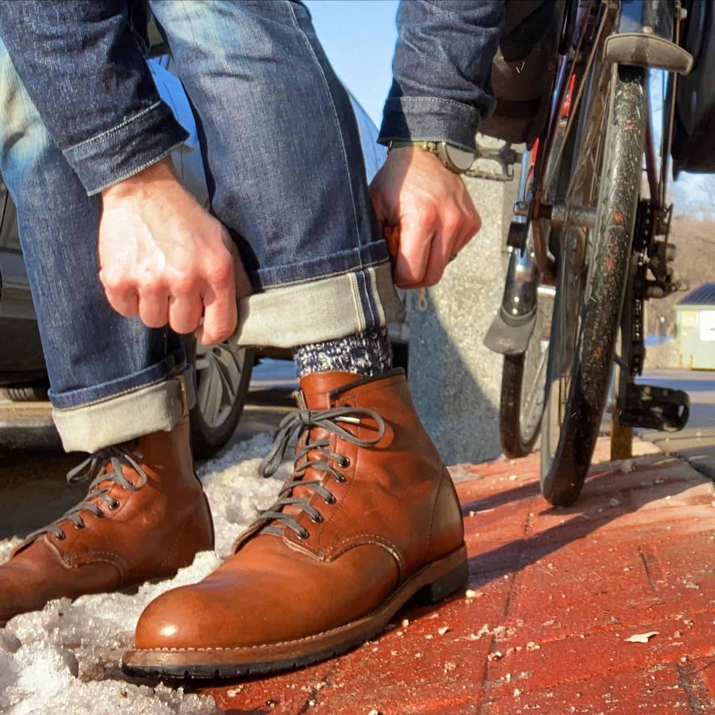 man folding jeans hem before riding a bike