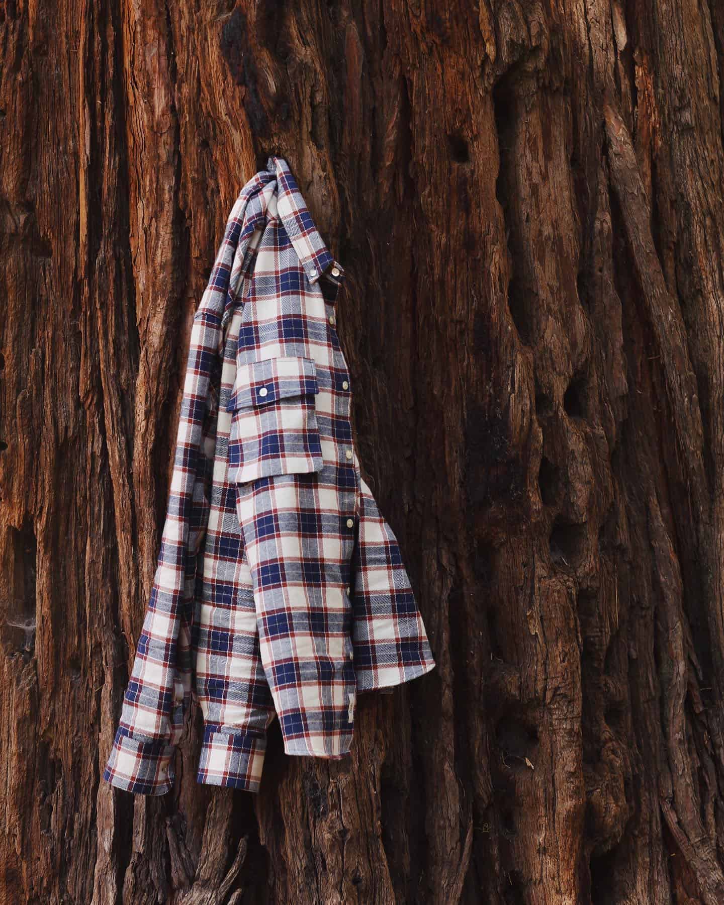 a checked shirt hanging on a tree