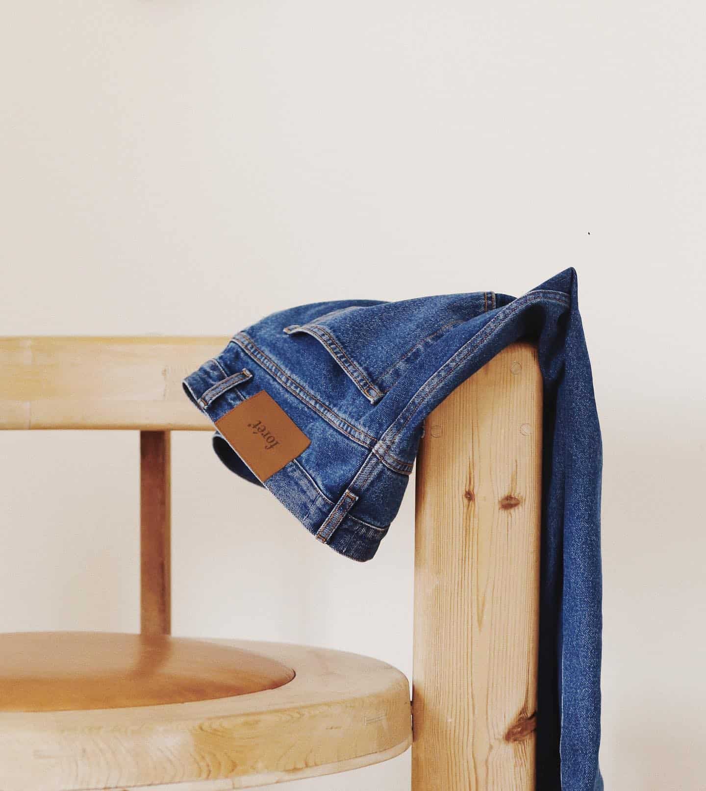 a pair of jeans hanging from a chair