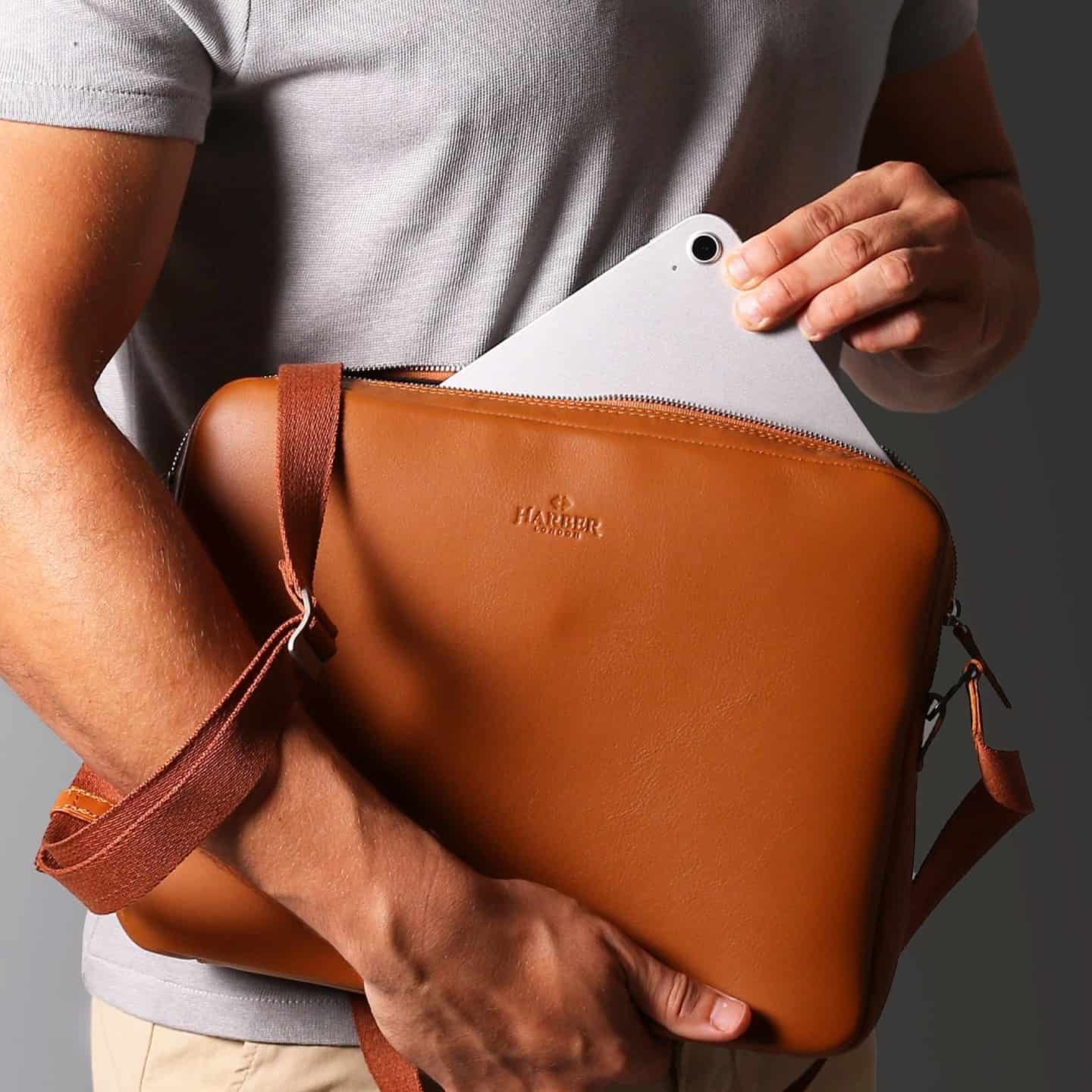man carrying a leather messenger bag by harber london