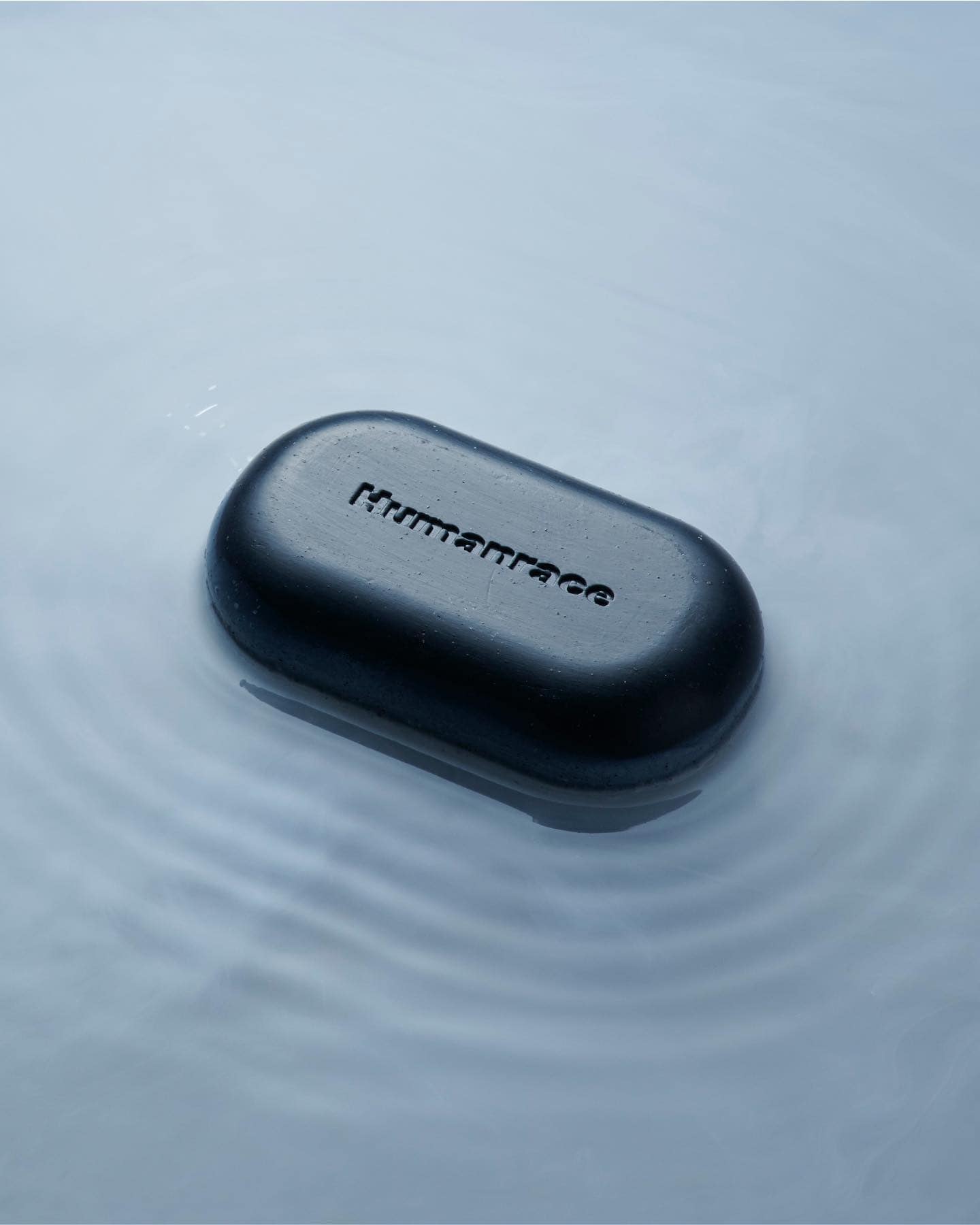 a bar of charcoal soap in shallow water