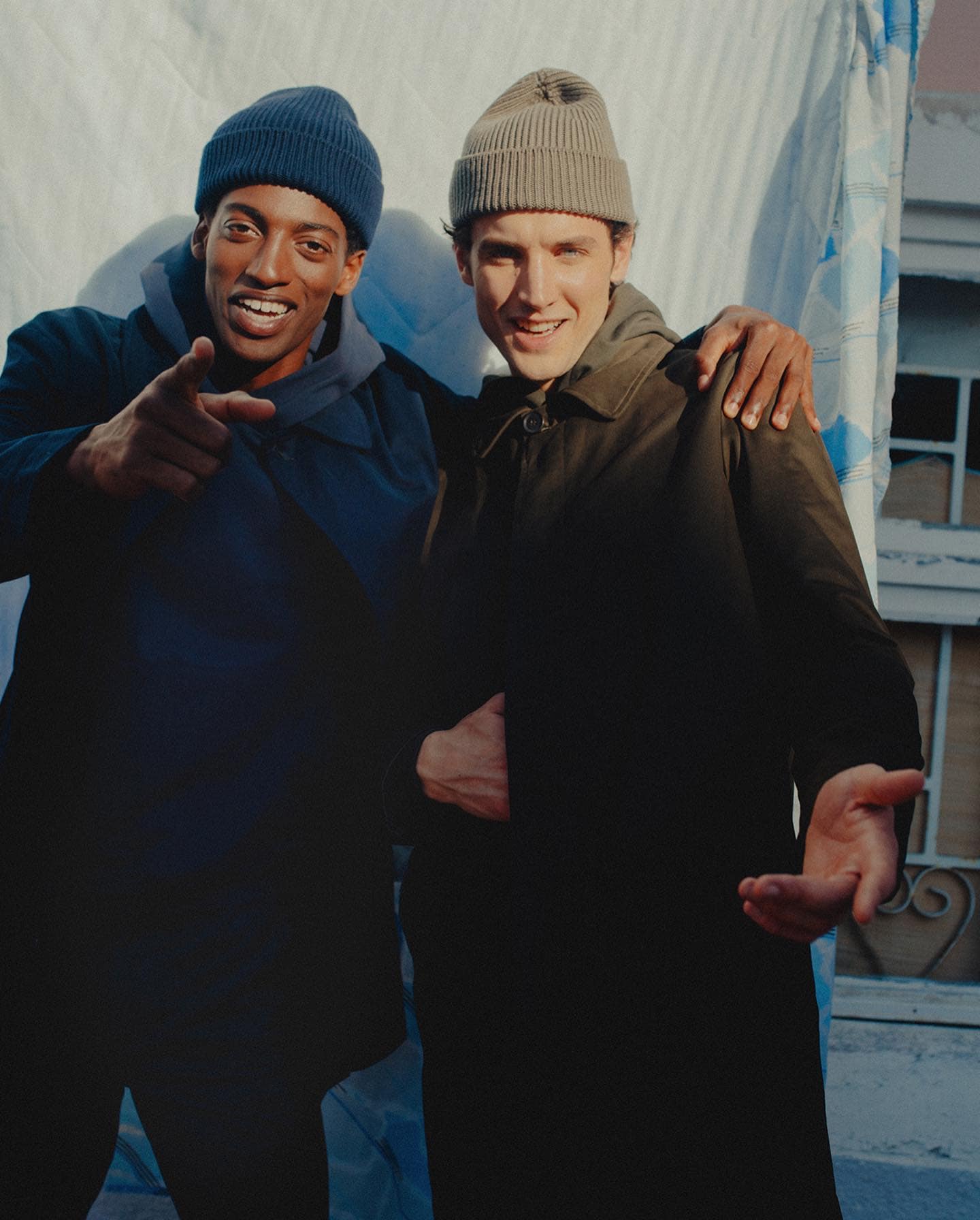 two men in coats and beanies