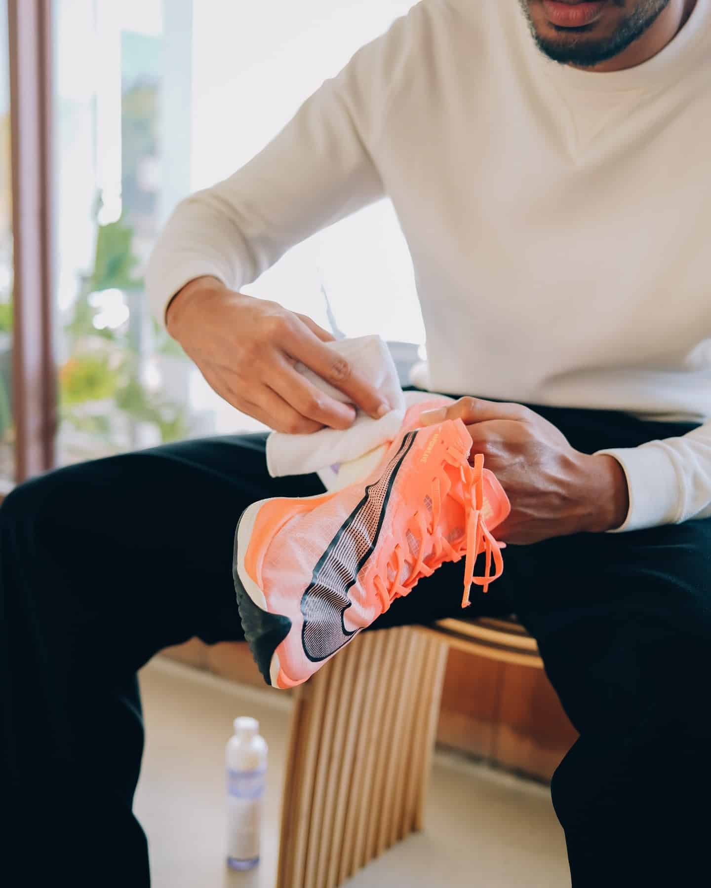 wiping a sneaker with a cloth