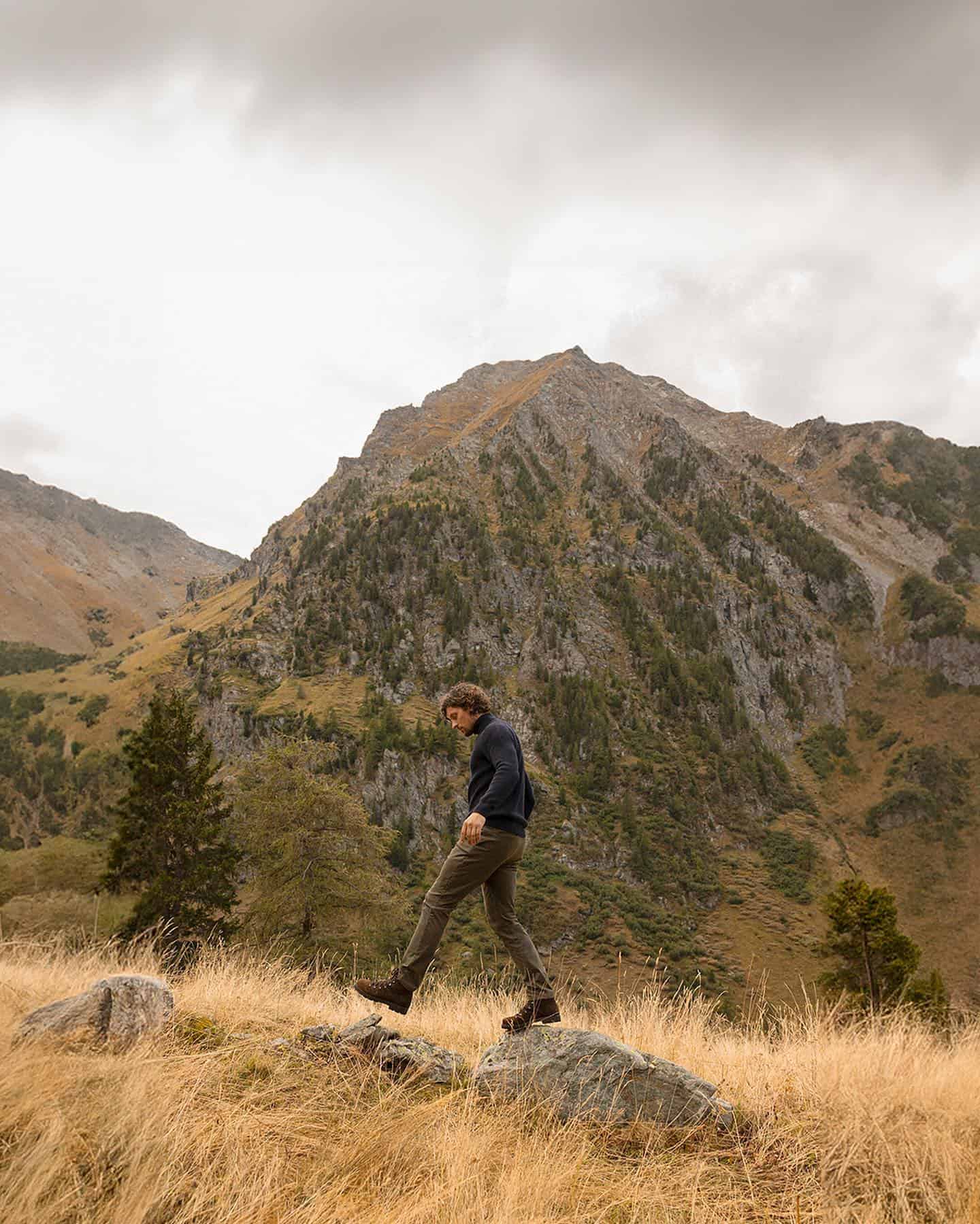 man walking on top of rocks